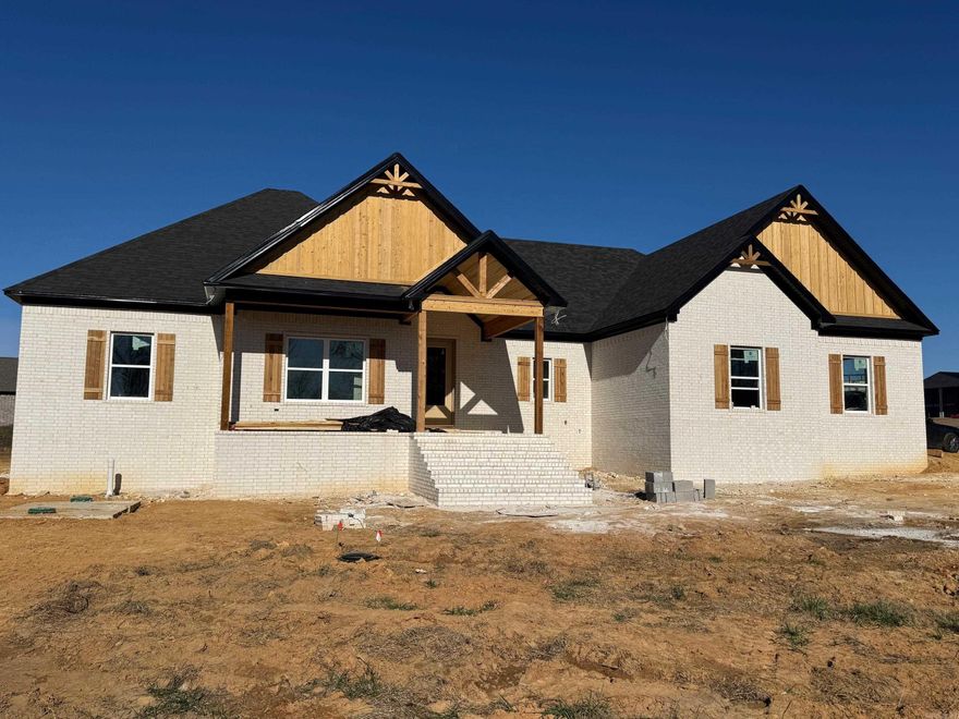 Beautiful New Construction featuring 4 bedrooms and 2.5 bathrooms. This open-concept floor plan makes excellent use of every square foot. The spacious kitchen includes a large island, and the living area offers a cozy fireplace. The laundry room features a locker-style drop zone, and the closets come with built-ins for added organization. Enjoy outdoor living on the covered back porch, perfect for entertaining. The home also includes a partially floored attic for extra storage. All of this sits on approximately one acre. Taxes are estimated on the lot only. This is a must-see!