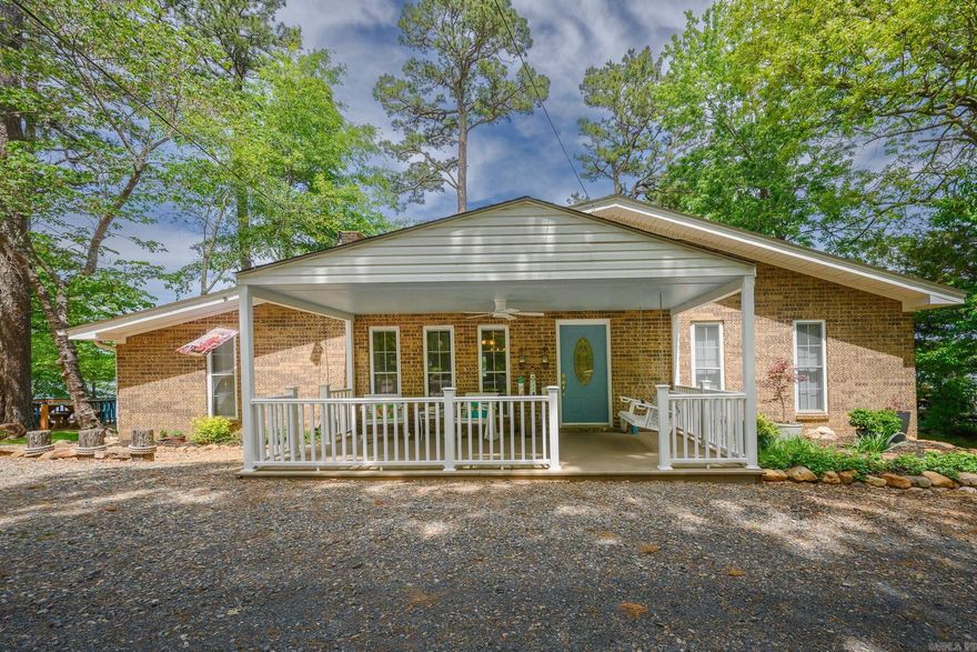 This is your opportunity to own almost an acre on Mena Lake, Arkansas—properties like this are rarely available. Location says it all, and remodeling says the rest! This move-in ready 3BR/2BA home offers the perfect blend of recreation, comfort, and scenic beauty with a center lake view overlooking Rich Mountain and future trail systems. Enjoy private lake access with a covered dock, new decking, updated walkway, lighting, and electric—perfect for fishing, kayaking, and boating. Outdoor living shines with a redesigned lakeview deck accessible from the sunroom and master, a lakeside patio, fire pit with seating, and a new 10x20 front porch. Extras include a bocce ball court, walkways/areas for cornhole, fruit trees, and beautiful landscaping. Inside, the open-concept layout features a fully remodeled kitchen with a large granite island, custom cabinetry, pantry, reverse osmosis system, and high-end appliances. The  sunroom offers year-round lake views with a new PTAC unit. Additional highlights include updated flooring, expanded guest bath, spacious master suite with deck access, walk-in shower, and separate laundry. Oversized garage and  workshop included. Lake life is calling!