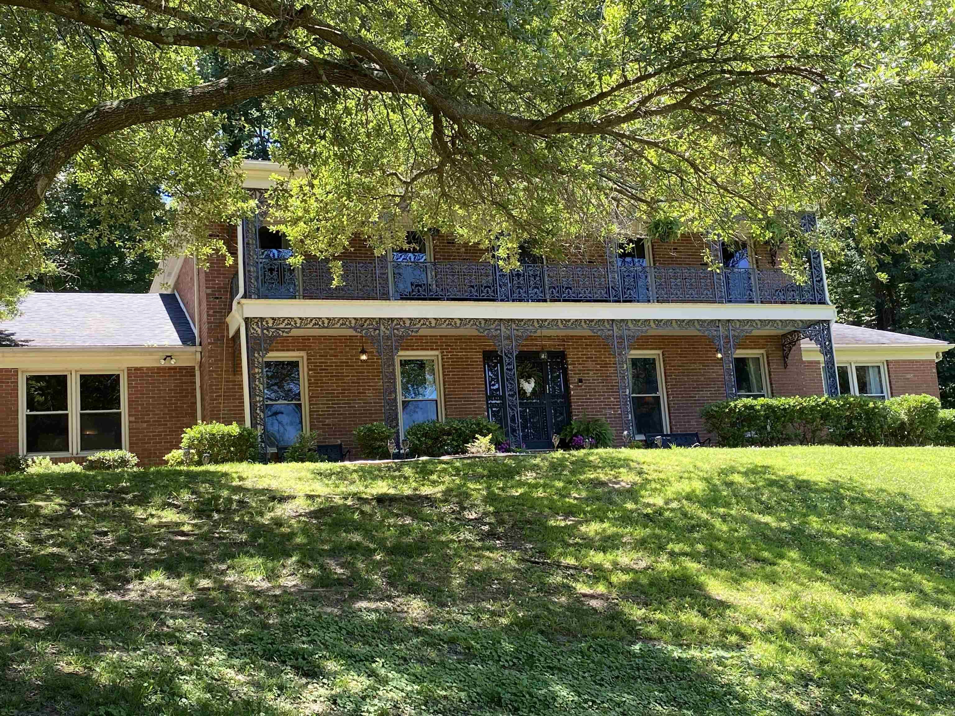 This Spectacular New Orleans Style Home is a must see ! This two-story custom-built has designer touches throughout. The brick beauty features 5 spacious bedrooms and 3.5 baths. The impressive formal living room and dining room are perfect for entertaining. The fully-equipped kitchen is a chef's dream furnished with stainless steel appliances and pendant lighting. The large center island/bar is desirable for family gatherings. The stunning family room boasts a large fireplace, built-in bookshelves and an exceptional wet bar. Other features include sunroom, separate utility room, security system, private backyard and double carport.