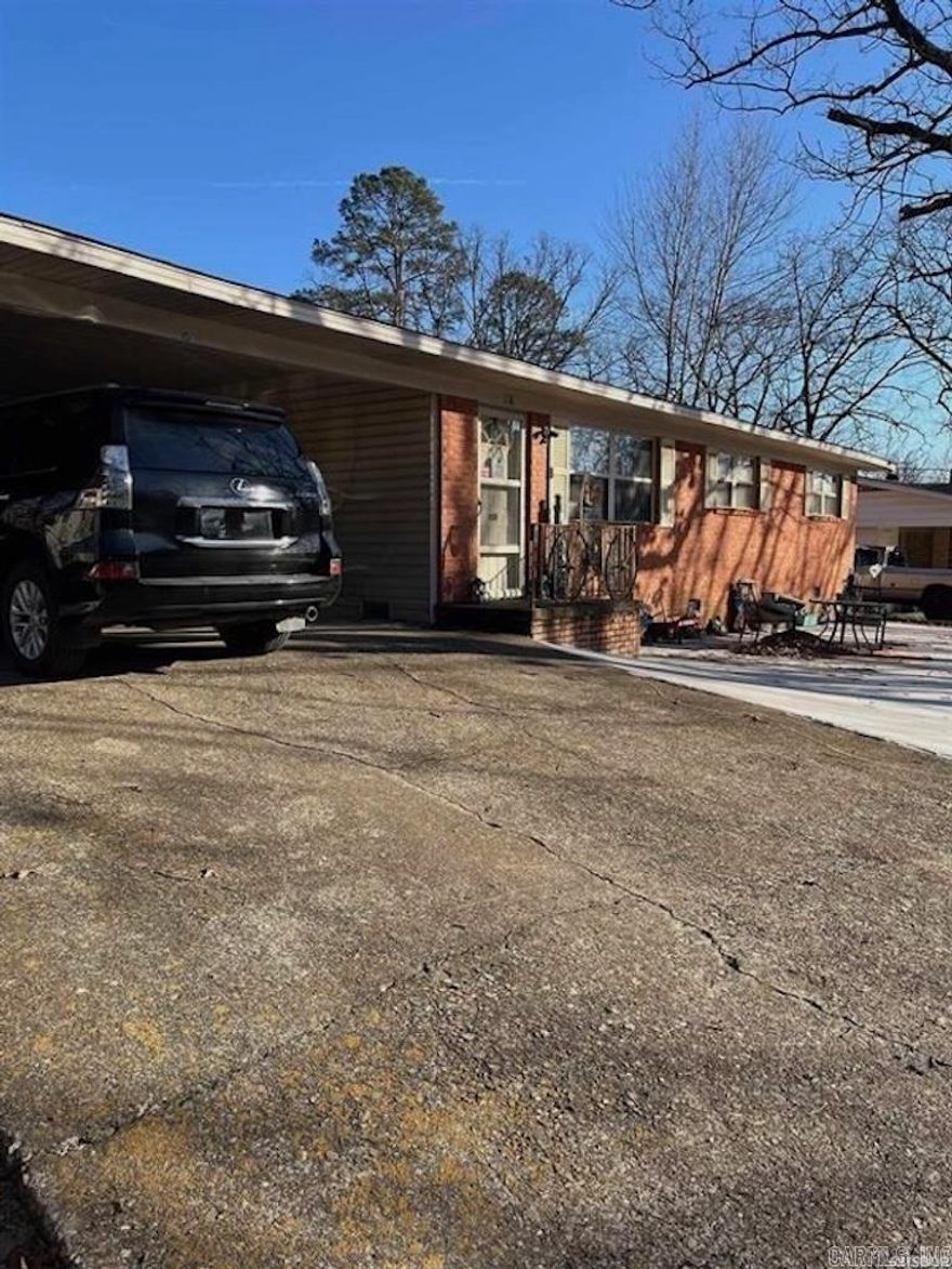 This 4 bedroom, 1.5 bath brick and vinyl home offers approximately 2,222 square feet of functional living space. Hardwood floors run throughout the home, complementing the comfortable layout. The main living area features a fireplace, while a bonus room provides flexible use options. Additional highlights include a workshop, paved driveway, and a small back patio ideal for outdoor enjoyment. This property offers a blend of practical features and versatility in a well-rounded home.   Agent related to seller.