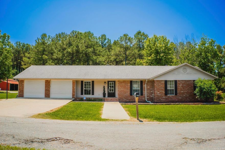 If you’ve been looking for a little space outside of town without giving up convenience, this one-story brick home offers the best of both worlds. Located at the end of a quiet street with only four homes, the property sits on approximately 4 acres with a peaceful country setting, open pasture, mature trees, and a large red barn.  The home features 4 bedrooms, 2 bathrooms, solid surface flooring throughout, and a functional layout with comfortable living spaces. The den features vaulted ceilings, and the kitchen has a fresh, updated feel with white cabinetry, white countertops, tiled backsplash, and bar seating open to the living area. The dining space overlooks the backyard and brings in plenty of natural light.  Outside, you’ll find a fenced backyard, plenty of room to spread out, and space for animals, gardening, hobbies, or simply enjoying the quiet setting. Additional features include a spacious laundry room and a 2-car garage with extra storage space.  Properties with acreage and this kind of setting close to town are hard to find - call me today to schedule your private showing.