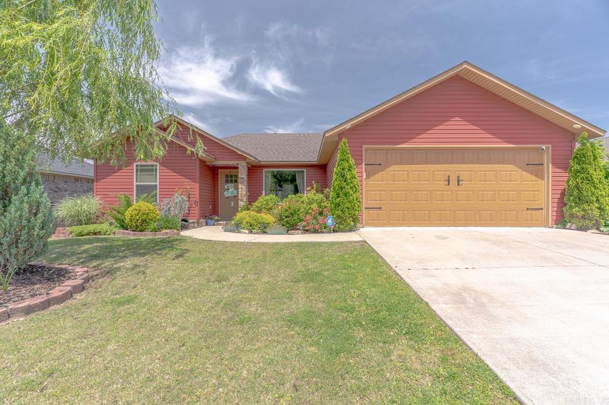 Welcome to 309 Elizabeth Dr in Paragould, AR! This one-of-a-kind 3-bedroom, 2-bath home stands out with its bold red exterior and timeless curb appeal. Inside, you’ll find an open floor plan with a large front window that fills the living space with natural light. Built in 2020, the home offers 1,303 sq ft of well-planned space, an architectural shingle roof, and a spacious two-car garage. Step out back and you’ll discover one of the home’s best features—a beautifully landscaped yard filled entirely with low-maintenance perennials that return year after year. Whether you’re enjoying your morning coffee or winding down on the deck in the evenings, the peaceful setting makes this backyard feel like a retreat. Don’t miss your opportunity to own a truly unique home in the established neighborhood!
