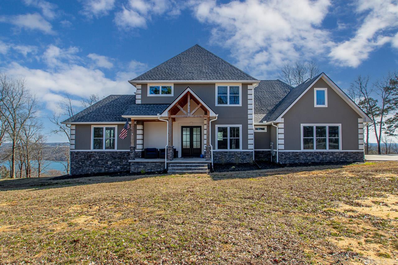 Wonderful Views of Greers Ferry Lake! This lovely and spacious four bedroom home sits on 3.10 acres and offers privacy and expansive lake views. Features include the great room with tall ceilings and lots of glass, perfect covered outside living space, three car garage, separate large shop building, and a primary suite that must be seen. Gorgeous home!