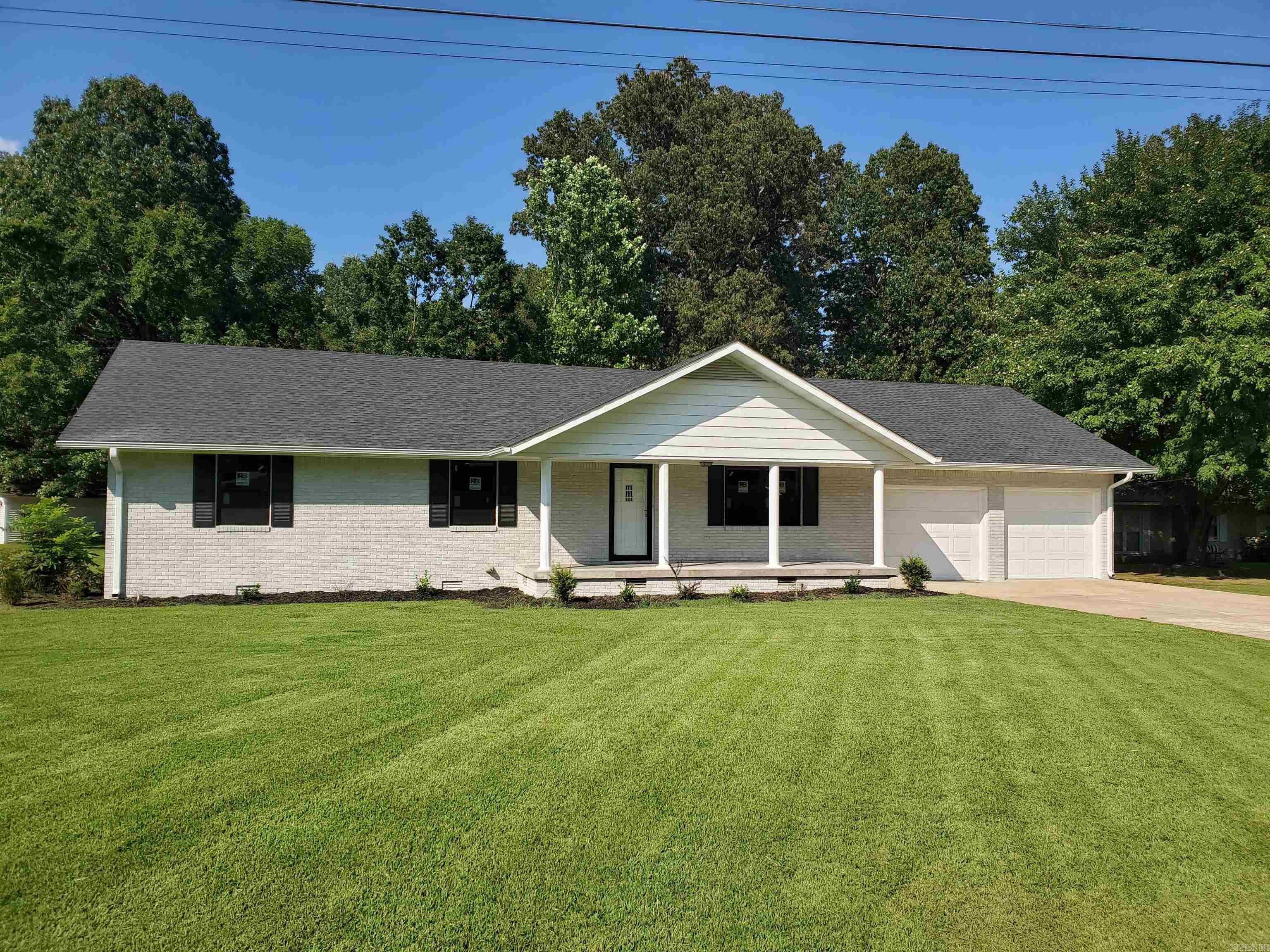 1017 Homecrest Dr in Piggott, Ar. is a 3BR, 2BA, 1,581SF home sitting on a huge 0.67-acre lot in the heart of Ballard Heights just beside the Sugar Creek Country Club! This stunning brick home has been completely gutted and remodeled from top to bottom, inside and out! The kitchen is an absolute work of art with stunning new stainless-steel appliances and a gorgeous new granitite countertop! The open floor plan with lots of windows allows for the sun to shine throughout the kitchen, dining and living room areas! A peaceful sunroom, just off the dining room, lets you relax and soke in the beautiful backyard overlooking sugar creek. Three large bedrooms gives everyone their own private space. The master has its own newly remodeled bathroom! The large 2 car garage has a built-in workshop that gives plenty of space to work on projects and store your tools. The huge 0.67-acre lot gives the kids plenty of room to play ball, or to plant that dream garden, or build that perfect man-cave shop you've always wanted! This amazing property, in one of the best neighborhoods around, can be your forever home!!