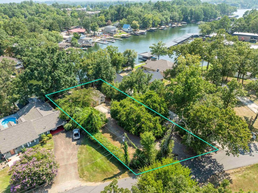 Discover the incredible potential of this south-facing lake lot on Lake Hamilton, perfectly situated for building your dream lakeside retreat. With 80 feet of tranquil water frontage, enjoy peaceful evenings on the back patio. This prime location offers easy access to Hot Springs' vibrant attractions, including Central Ave’s restaurants, shopping, marinas, Oaklawn, and downtown. Nestled in a cove, the property ensures minimal wave action, preserving your boat and dock. Although the home is nearly a century old, the true gem is the exceptional lakefront land, measuring 80 by 102 feet. Seize this rare opportunity to own a slice of serene lakeside beauty and craft lasting memories. Due to the seller's health conditions, the home itself is not available for showings, but you can schedule a viewing of the lot with Rachelle at 501-545-0432. The home remains occupied, so access is limited.