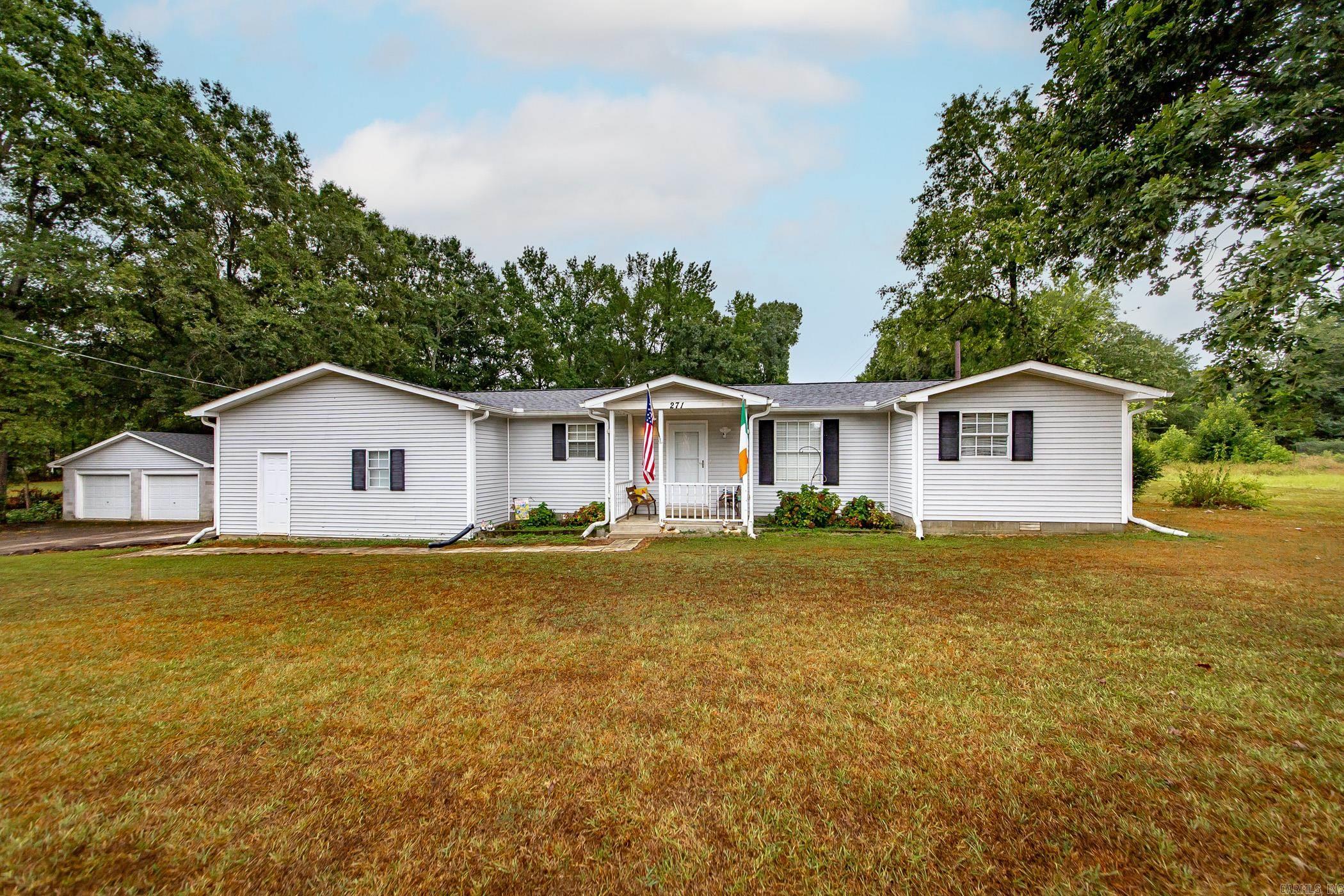 Plenty of space to enjoy the outdoors on this 2.5 acre property with a pond and approximate 12x12 shed with electricity! 4 bedroom, 2 bath home with 2 car attached garage and 2 car detached garage, spacious kitchen with island, nice sized living room and den, formal dining room with fireplace, and this home has a Generac whole house generator approx. 3 years old. New roof on home, detached garage, and shed (approx. 2 years old). Some newer flooring was added in 3 bedrooms, living room, and hallway. 2 refrigerators, washer, dryer, and freezer will convey to Buyer. Taxes stated are after homestead credit. Agents, see remarks.