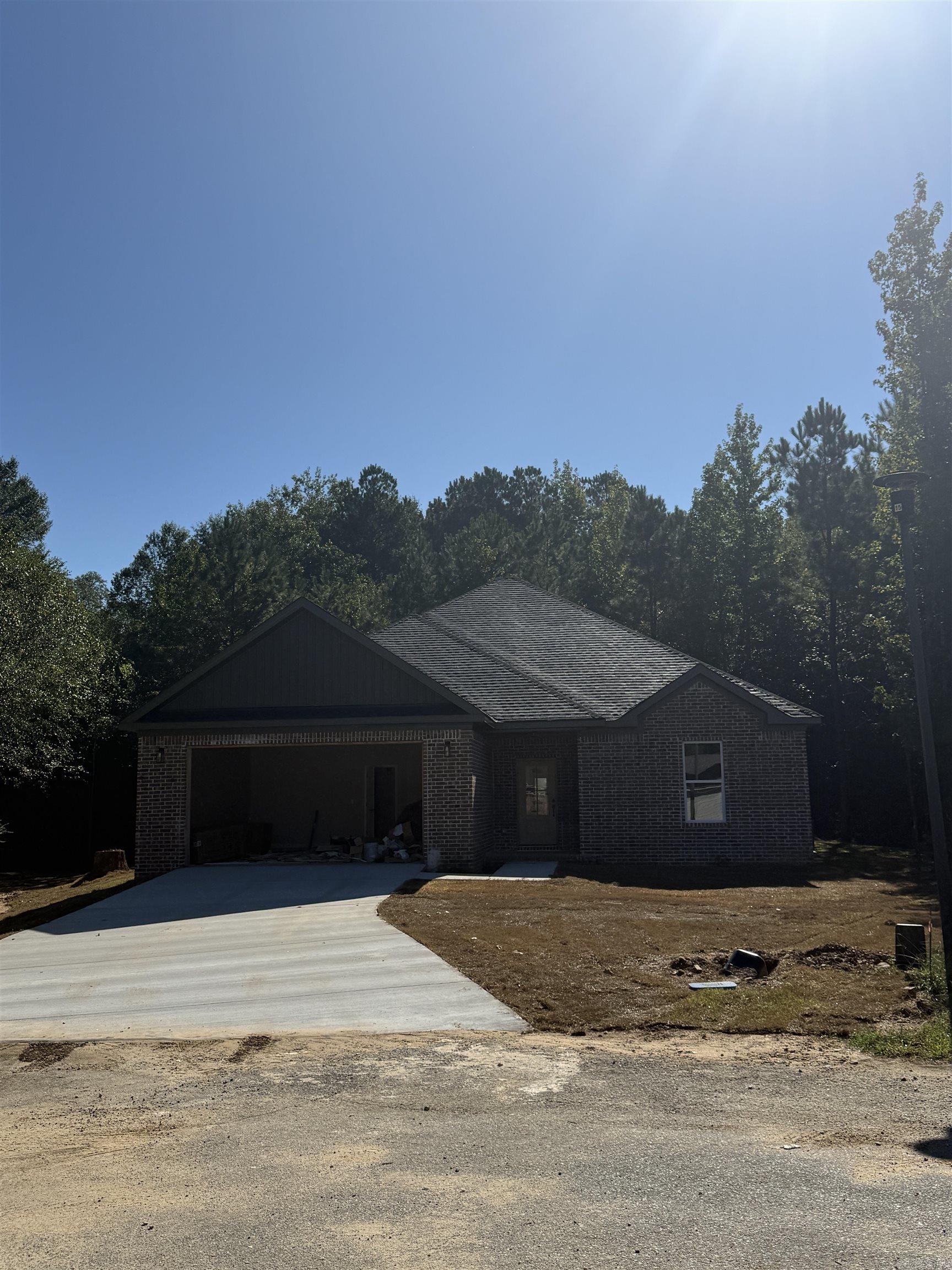Welcome to your brand-new home at the end of a quiet cul-de-sac in the desirable Meadow Creek subdivision of Haskell, AR. This thoughtfully designed residence combines modern finishes with everyday convenience, making it perfect for families or anyone looking for a fresh start. Step inside to find luxury plank vinyl flooring throughout, offering both durability and style. The spacious open floor plan creates a seamless flow from the living room to the kitchen and dining area. The kitchen features granite countertops, custom cabinetry, and all-electric appliances, ready for both weeknight dinners and weekend entertaining. The primary suite includes a spa-like bath with a beautifully tiled walk-in shower, double vanities, and a large walk-in closet. Additional bedrooms are generously sized, offering comfort and flexibility for family, guests, or a home office. Located just minutes from Harmony Grove Schools, this property offers the peace of cul-de-sac living while keeping you close to town amenities. With modern construction, quality finishes, and a prime location, this home is move-in ready and built to impress.