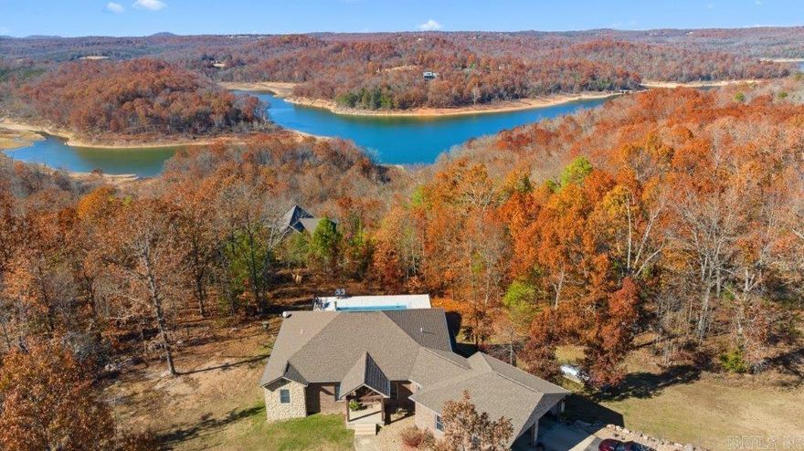 Where your dream home becomes a reality! All brick home on 3 AC overlooks Lake Norfork. Open floor plan. MBRM on main level. BA:2 BRM, BTH, Safe room, partially fin. bonus room. Built-in pool. 40x60 bldg., H/C. See Assoc. Docs for all amenities.