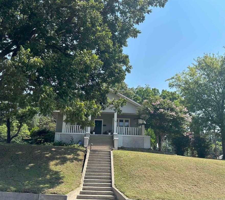 This home embodies the Southern charm, featuring a spacious front porch perfect for enjoying your morning coffee while overlooking the town. The spacious backyard provides plenty of space for family gatherings, reunions, and barbecues. A double carport offers convenient parking, while the kitchen impresses with quartz countertops, a butler's pantry, and tall ceilings complemented by warm hardwood floors. Large windows throughout the home offer stunning views from every room. The residence includes three generously sized bedrooms and two and a half bathrooms. The master suite boasts a Jacuzzi tub, while the other bathroom is beautifully remodeled with a ceramic tile shower and is fully handicap accessible, complete with an extra-wide hallway. With numerous updates throughout, this home is truly a must-see. Don't miss out on this opportunity-call today to schedule an  Seller will pay up to 6% of buyers closing