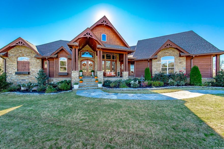 Step into a masterpiece of craftsmanship and comfort at this 4,290 sq. ft. gem, nestled on 1.11 acres at the end of a peaceful cul-de-sac in the prestigious Indian Knob subdivision. Just 2 minutes from downtown Mountain View, this home blends rustic elegance with modern luxury. Exterior Highlights: Stunning western cedar and native stone façade. Picturesque exterior lighting enhancing its charm. Full-house generator for peace of mind.  Enclosed porch with an outdoor kitchen, grill, and seated bar for year-round entertaining.  Back deck with composite decking for longevity. Interior Features:  5 fireplaces, adding warmth and ambiance. Exquisite architectural details, including: A wood barrel ceiling in the family room, An inverted gazebo wood ceiling in the breakfast area, Custom-built interior doors throughout. Formal living and dining rooms with soaring 21-ft ceilings and a semi-open concept. A sumptuous master suite with custom tile and woodwork, a walk-in closet featuring detailed wood accents and specialty niches, and a spa-like bath. Conveniences Galore:  Central vacuum system for effortless cleaning. Two-car garage.  4 bedrooms, 3.5 baths, offering ample space for the family