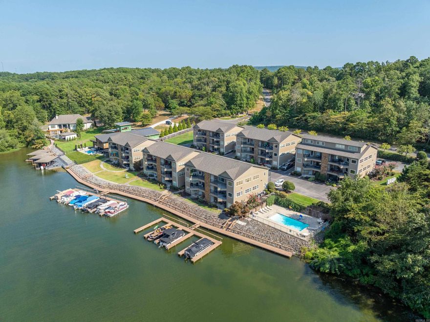 2-bedroom, 2-bathroom condo with boat slip on Lake Hamilton. This second floor condo features beautiful northern facing views of Lake Hamilton and Garvan Gardens, allowing for a wonderful view of the lake and sunsets without the sun beaming in.    Talk about square footage, over 1450 sq feet. Features include open concept kitchen, large rooms, gas fireplace, cozy balcony right on the lake with entrances off master bedroom and living area making it perfect for comfort, relaxation, seamless living and entertaining.   Enjoy a private pool right on the lake, a wonderful boardwalk great for fishing or evening stroll . Conveniently located not far from the bypass In Lakeside school district. Don’t miss the opportunity to own this beautiful condo. Schedule a tour today!