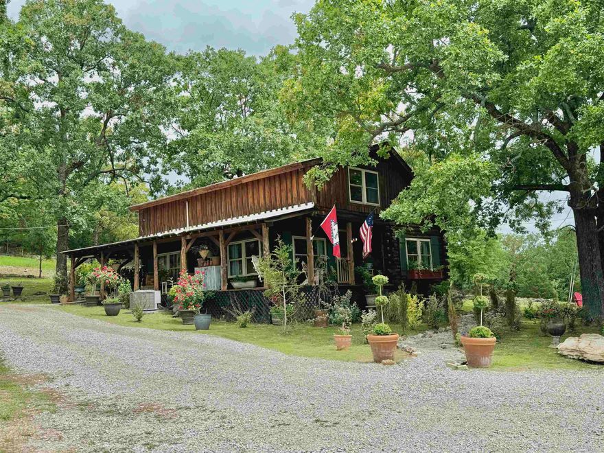 Nestled under the large Oak trees, sits this 3 bedroom, 2.5 bath recently remodeled, log home on 10 acres! Driving up to this property truly takes your breath away because of the beautiful landscaping, quiet atmosphere, and privacy. The property is all fenced and has no restrictions! This home features a large back with a fenced in yard for your dog, a side porch wrapping around to the front for a perfect view of the property. The main floor of the home is an open living room, kitchen area, dining room, the primary bedroom & bath, and laundry room. Upstairs has two large bedrooms, a full bathroom, and tons of storage space!  The property includes a chicken coop, goat barn, storage shed, and more! This property is the perfect place to have a hobby farm/homestead!