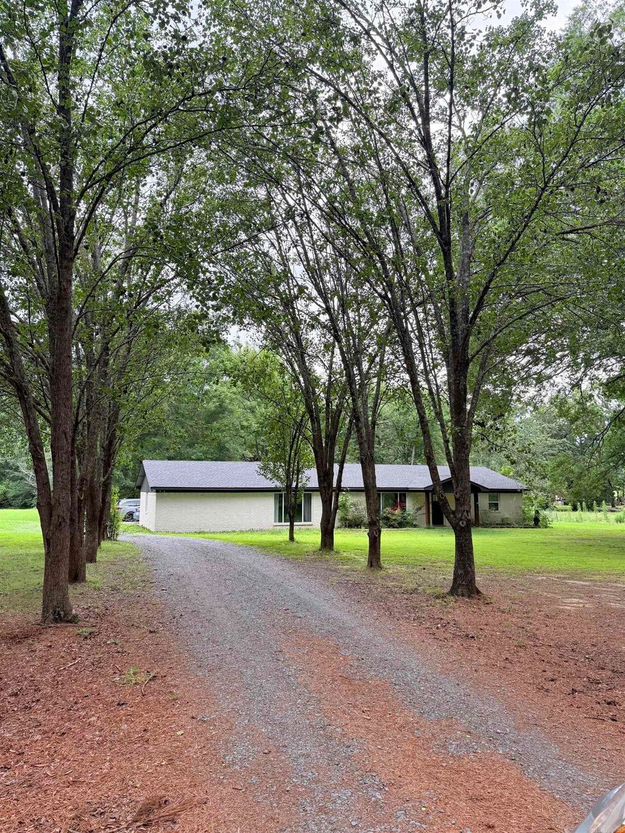 Completely remodeled down to the studs in 2021, this stunning home on 5 acres offers the perfect mix of modern updates and peaceful country living. Major items including the roof, HVAC, tankless water heaters, and windows are all approximately 5 years old. Inside, you’ll love the painted rock fireplace with gas logs and built-ins, LVP flooring throughout with tile in wet areas, and no carpet anywhere. The kitchen features granite countertops, a gas range, and an oversized single-basin sink. The extra-large primary suite includes a huge walk-in closet with dresser island, plus a spa-like bath with a rain shower and soaking tub. Additional features include a spacious mud room and a beautiful covered back porch with wood slat ceiling. If you’ve been looking for acreage with modern finishes and move-in-ready updates, this is it!