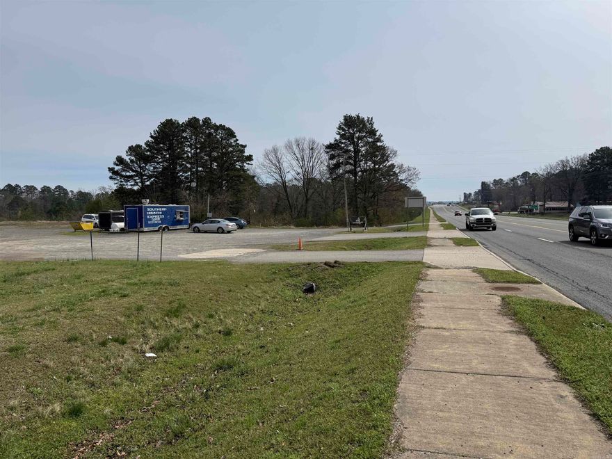 2.97 +/- acre commercial lot on Hwy 65 S. in Clinton, AR with approx. 13,000+ vehicles per day (2024 ARDOT). Property features an established food truck space currently leased with water, sewer, and electric in place. Additional space available with water and electric for expansion or additional tenant. Three separate driveways provide excellent access and visibility. Located near Walmart, convenience stores, post office, hospital, and other businesses. Ideal for commercial development or investment opportunity.