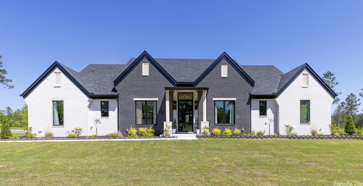 This stunning home is situated on 10 acres! 5 bd, 3.5 ba with a bonus room on its own mini-split, 3 car garage, covered back porch with ceiling fans for those warm summer days and a cozy gas fireplace for cool fall evenings. This home features a whole home generator, wired entire home camera system and security system. Automated exterior lights, all LED lighting Spray foam insulation and Pella black on black double insulated windows. Electric heat/air with heat pump, Talk about energy efficient! The kitchen will make you fall in love with beautiful matte white/brushed bronze Cafe brand appliances, 6 burner commercial style range, Quartz waterfall counter tops, and LVP flooring. Two sets of Jack and Jill bedrooms are set apart from the Primary suite which features a luxurious soaker tub and walk through double shower, his and hers closets connect to a spactious laundry room The immediate yard features sod and an additional 3 acres has been disked and seeded this spring. There is a foundation pad ready for you to build your very own shop for all the ATV's you are going to want to enjoy this 10 acer wooded tract, Don't wait this home will not last long!