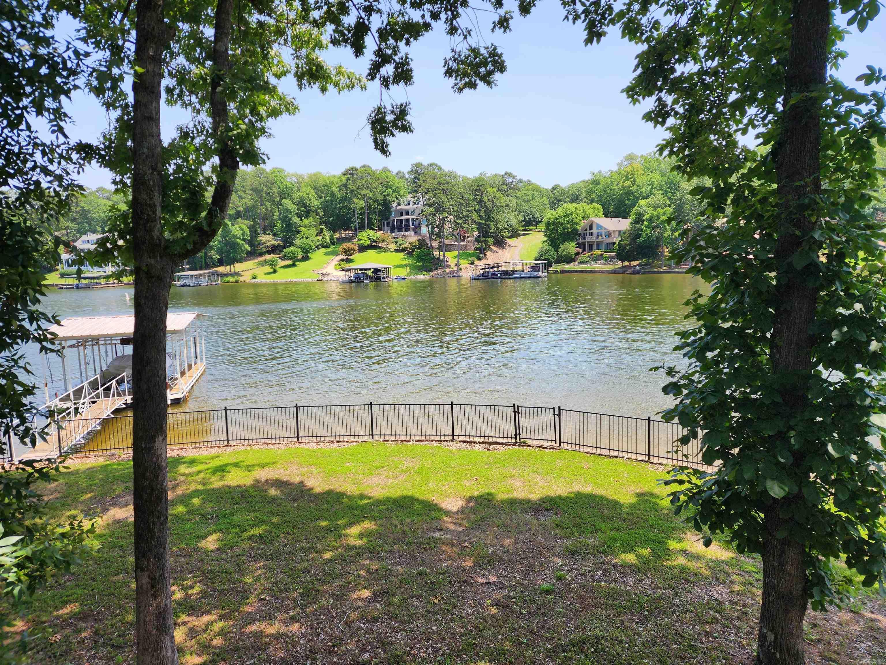 Lakefront Opportunity in Gated Driftwood Subdivision! Solid family home with 156 ft of lake frontage on a level lot. Located in the desirable Driftwood gated community, this property features a rock seawall and a spacious 3-car garage, lots of storage. The home is structurally sound and offers great potential with some TLC and updates—reflected in the price. Rare chance to own a Lake Home in a premier location with great possibilities!