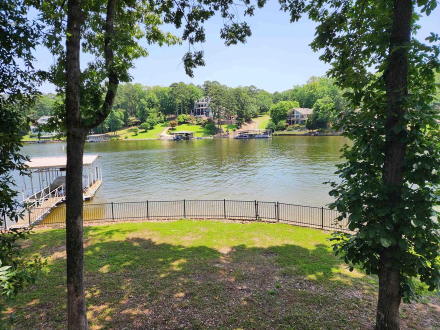 Lakefront Opportunity in Gated Driftwood Subdivision! Solid family home with 156 ft of lake frontage on a level lot. Located in the desirable Driftwood gated community, this property features a rock seawall and a spacious 3-car garage, lots of storage. The home is structurally sound and offers great potential with some TLC and updates—reflected in the price. Rare chance to own a Lake Home in a premier location with great possibilities!