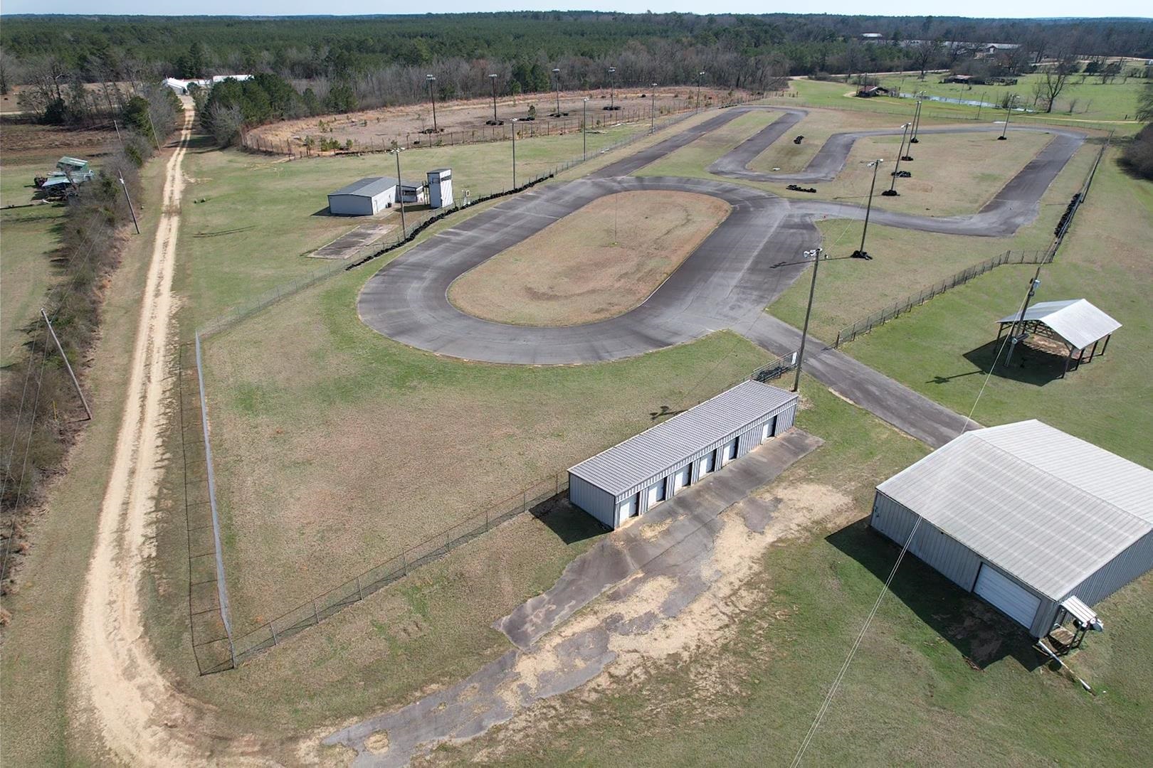 Calling all motorsports and outdoor enthusiasts! This 28-acre property is packed with potential and ready for your vision. Formerly a race track, it still holds the bones of its high-speed past but can easily be transformed into a commercial business, private retreat, or even a residential property. The 40x60 shop comes equipped with water and electricityāperfect for working on cars, equipment, or other projects. Thereās also a storage building and an additional structure with sewer, water, and electricity, giving you plenty of options. Want to switch gears? The old dirt track area could be converted into a nice-sized pond for fishing or relaxing. The commercial-grade septic system is already in place, and the property sits in a great community with friendly neighbors. Whether you want to revive its racing legacy or create something entirely new, this property is your blank canvas! Call 870-820-2578 or 870-226-2697.