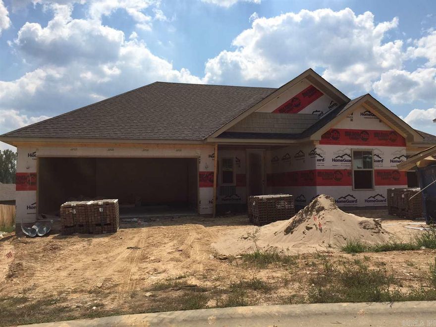 brick front home, open floor plan, crown molding, huge island in kitchen, granite counter tops throughout, handscraped wood laminate flooring in all main areas.  custom tile shower in master bathroom, covered back porch.