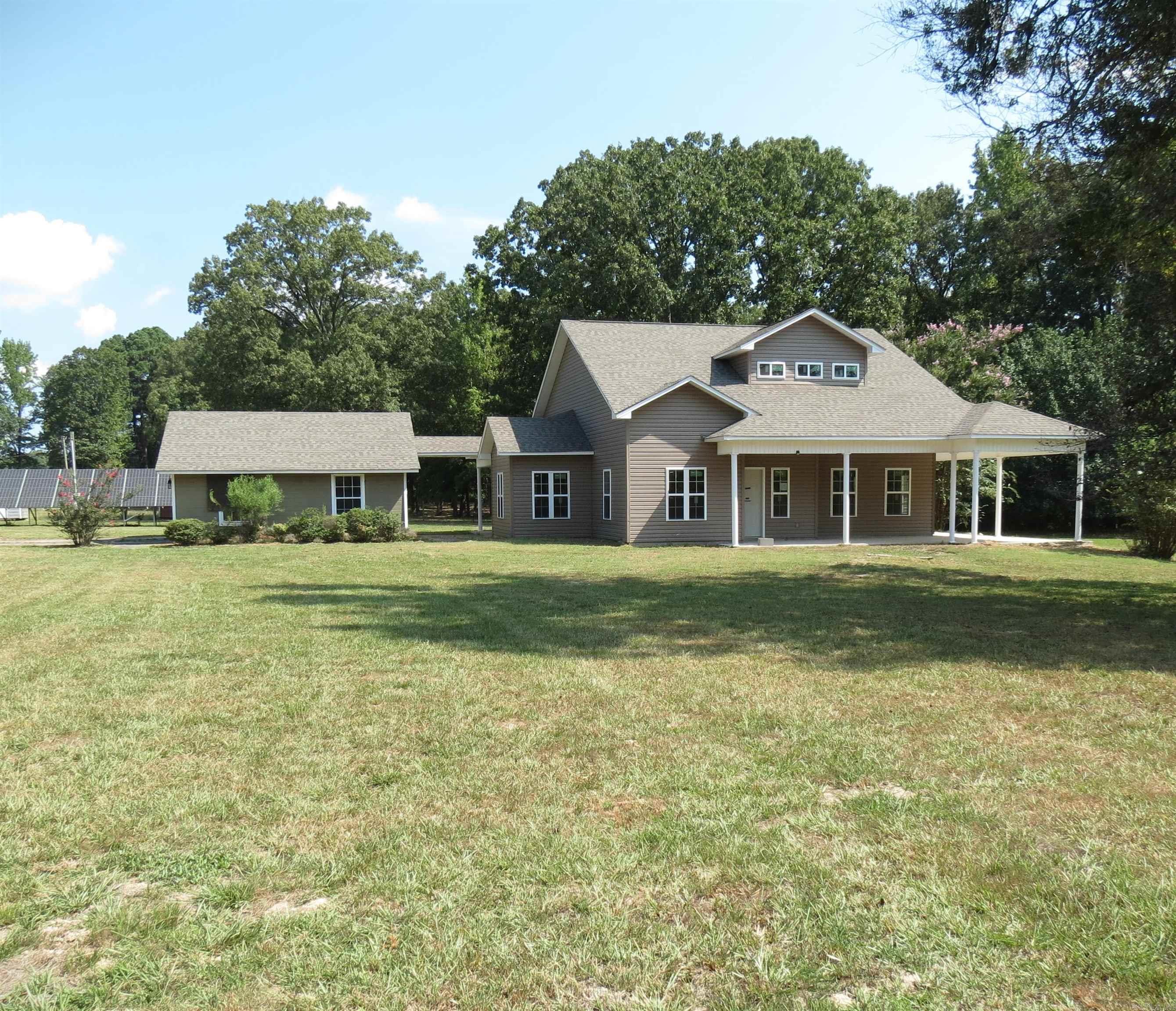 Wow this is a unique home!!! Located outside city limits on 4.064 acres. The original home burned and a new home was built on the slab. This is like moving into a brand new home! Discover the perfect blend of comfort and tranquility in the spacious two-story home in the rural setting. With 4 generously sized bedrooms, including a primary suite with ensuite bath. Lots of windows that flood the space with natural light. Detached garage. Taxes do not reflect the new home. Square footage is based off existing slab. Call today to own a slice of rural property. **Agents See Remarks**