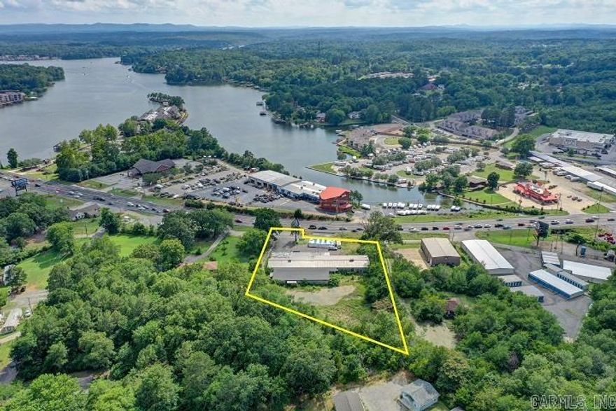 Property is ripe & ready for development--Huge Commercial Potential!! Approximately 2 acres and 190 feet of Albert Pike Road Frontage. Excellent access and visibility.  Daily traffic count of 34,000 cars per day.  All utilities available.  Across the street from Lake Hamilton.  Value is in the land.