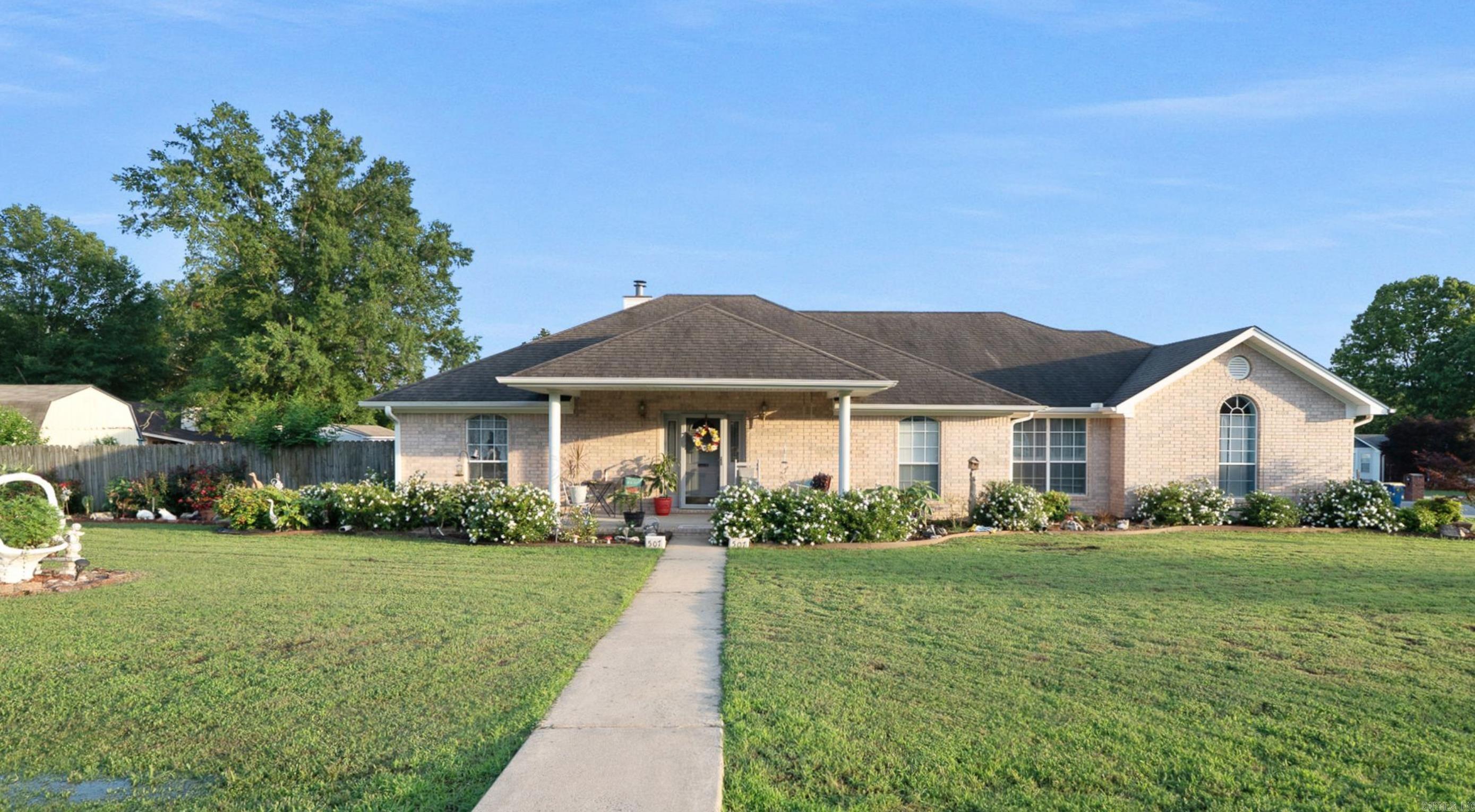 This beautifully maintained all brick, three bedroom, two bath home is a must see! Offering over 2000sq ft of living space on a quarter acre lot, this property offers comfort, style and function. The interior features new LVP flooring throughout the main living area, kitchen, and primary bedroom. The recently painted kitchen adds a bright touch to the heart of the home. This home has an eat in kitchen and a separate dining room with plenty of room for hosting events. There is a spacious sunroom at the back of the home for relaxion and an indoor garden sanctuary. The back porch provides ample space for entertaining guests. The large from porch welcomes you with a classic porch swing and plenty of room for visitors. The landscaping of this property is truly a showstopper adding beautiful curb appeal. There is an outdoor building offering storage for your lawn mower and other outdoor essentials. This property is located convenient to Southside Elementary in a family friendly neighborhood. Call today to view this wonderful property!