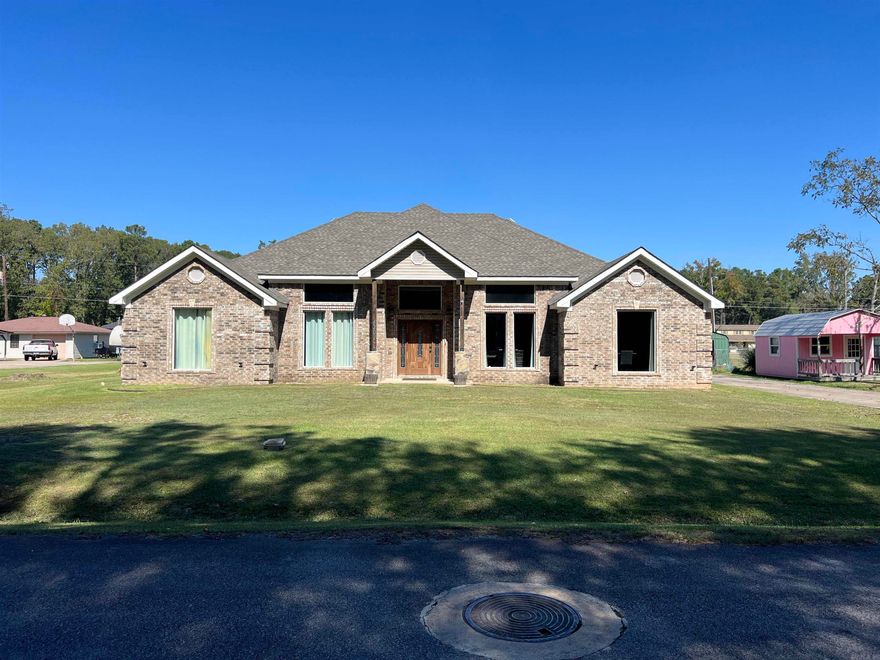 Welcome to this spacious and versatile brick home offering four bedrooms, two full baths, and a fantastic bonus room upstairs currently being used as a game room. The main level features a large eat-in kitchen with an oversized island, breakfast bar, and ample cabinet space, perfect for gatherings and everyday living. A separate dining room adds a touch of elegance, while the large living room showcases beautiful chandeliers and plenty of space for entertaining. The enormous master suite is a true retreat, complete with a garden tub, beautifully tiled shower, and big walk-in closets. A dedicated office provides the flexibility to serve as a fifth bedroom if needed. The large laundry room offers abundant storage, making household tasks easy and efficient. Outside, you’ll find even more to love — an additional home of nearly 700 square feet that’s ideal for guests or a mother-in-law suite. This secondary home includes two bedrooms, one full bath, window units, and a kitchen/living room combo. For the hobbyist or professional mechanic, there’s also a separate workshop equipped with a hydraulic lift. This property truly has it all.