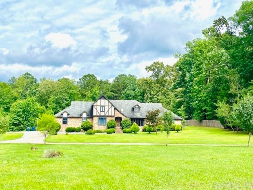 Charming Tudor-Style Home with Modern Upgrades on 2 Acres! Welcome to your dream home! This stunning 5-bedroom, 3.5-bath Tudor-style residence offers the perfect blend of classic charm and contemporary amenities. Nestled on a serene 2-acre lot, this 2-story home boasts a beautiful brick and stucco exterior, crowned with durable asphalt shingles. The recently installed wood flooring that runs throughout the main level of this spacious 3,454-square-foot haven welcomes you inside. The well-appointed kitchen, completely remodeled in 2022, features elegant new cabinets, stylish countertops, and fresh paint. Admire the beautiful granite countertops that make this kitchen a chef's paradise.   The expansive main-level master bedroom is a true retreat, complete with an ensuite bathroom and a generous walk-in closet. Two guest bedrooms downstairs and two upstairs offer ample space for family and guests, each with well-sized closets. The inviting living room is bathed in natural light, thanks to a large window that offers a panoramic view of the lush front yard. Adjacent to  **All furniture, window coverings, and décor accessories are separate from this listing agreement and are negotiable.**