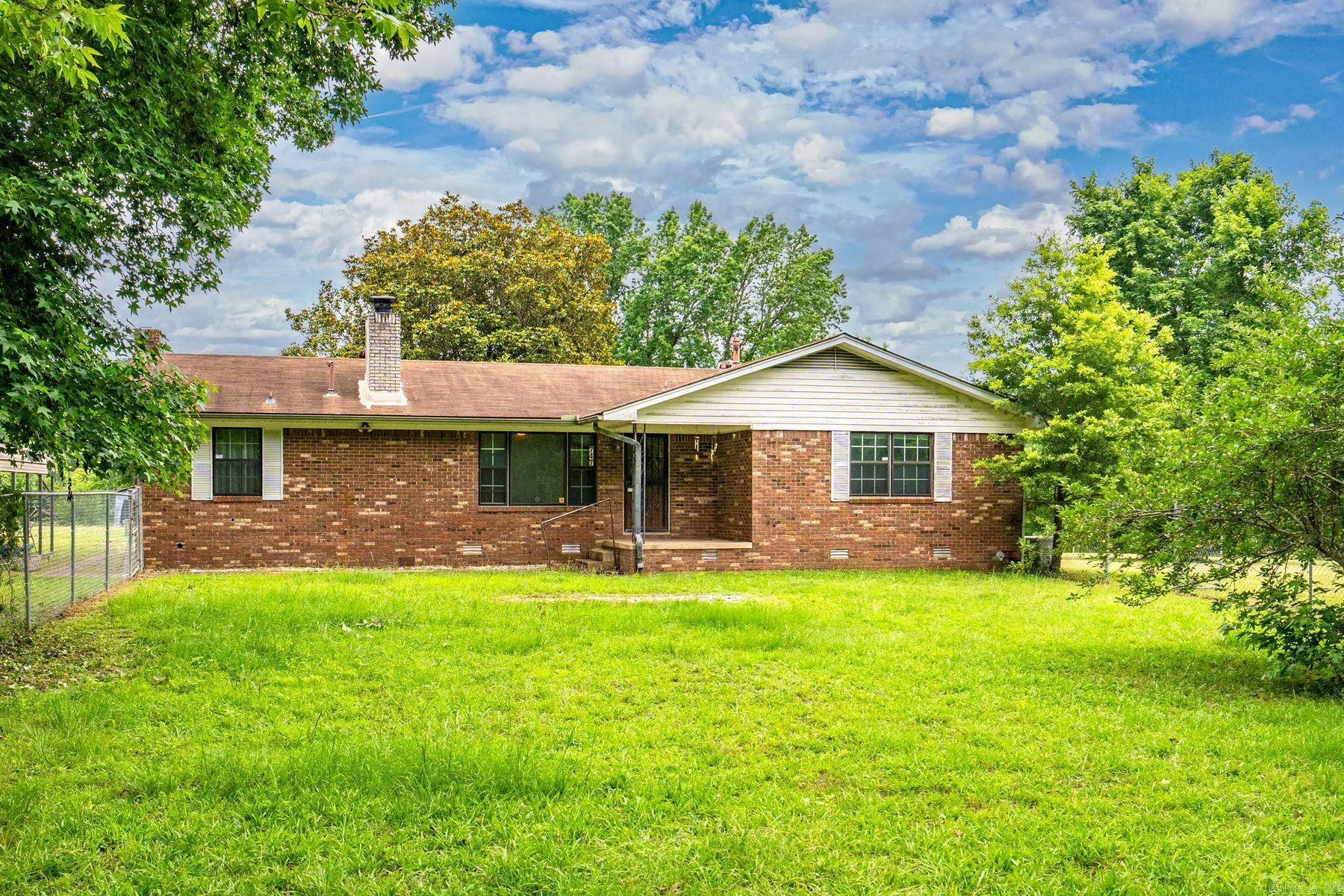 Charming All-Brick Home on 2 Acres! Built in 1975, this nice all-brick home offers 3 bedrooms and 2 bathrooms across 1,558 square feet of comfortable living space. Nestled on a beautiful, flat 2-acre lot, the property includes an old barnāperfect for storage, hobbies, or even a dream garden. This one-level home features a cozy living room with a fireplace, a separate den, and a spacious eat-in kitchen with nice cabinetry, a refrigerator, and an electric range. The partially fenced yard provides plenty of space for kids or pets to play, and a gas generator adds peace of mind. Enjoy outdoor living with a covered back porch and an oversized two-car detached carport. Whether you're starting a family or looking to downsize and enjoy country living, this home offers the best of both worldsāpeaceful surroundings with convenient access to town.