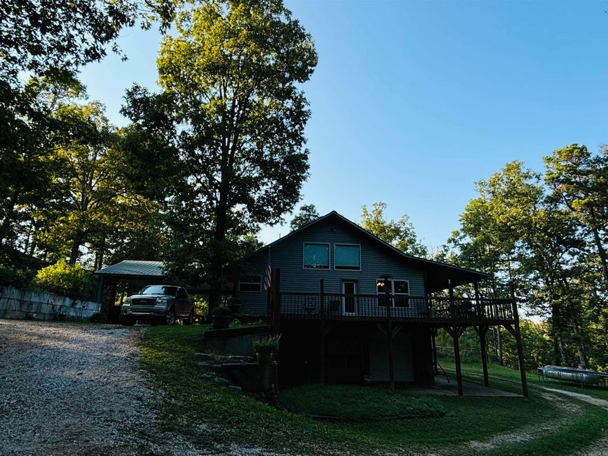 Great private location near White River! This beautiful custom-built home with a 46X26 Shop is surrounded by 5 +/- wooded ac & is just 2 miles from a White River public boat launch & a few minutes from the music, shopping, & eateries of world renown Mtn View! The spacious open concept main living/dining area is perfect for entertaining with a high vaulted ceiling & large windows offering natural light & panoramic woodland views. Quality craftsmanship throughout, the main level has an inviting open kitchen with island & stainless appliances, walk-in pantry, half guest bath, primary bedroom with bath & walk-in closet & an open staircase leading up to the large 3rd level bedroom with half bath. Downstairs is a walkout basement featuring a big bonus room, a second large walk-in pantry/storage area, laundry room, bedroom, & full bath. Outside is a vast covered porch that wraps around each side plus a large, covered patio for relaxation & entertaining. The shop with lean-to is ready to store your RV, boat, & set up workbenches for tools. This is a must-see property with too many features to name. Call today for more info or to set up a time to view.