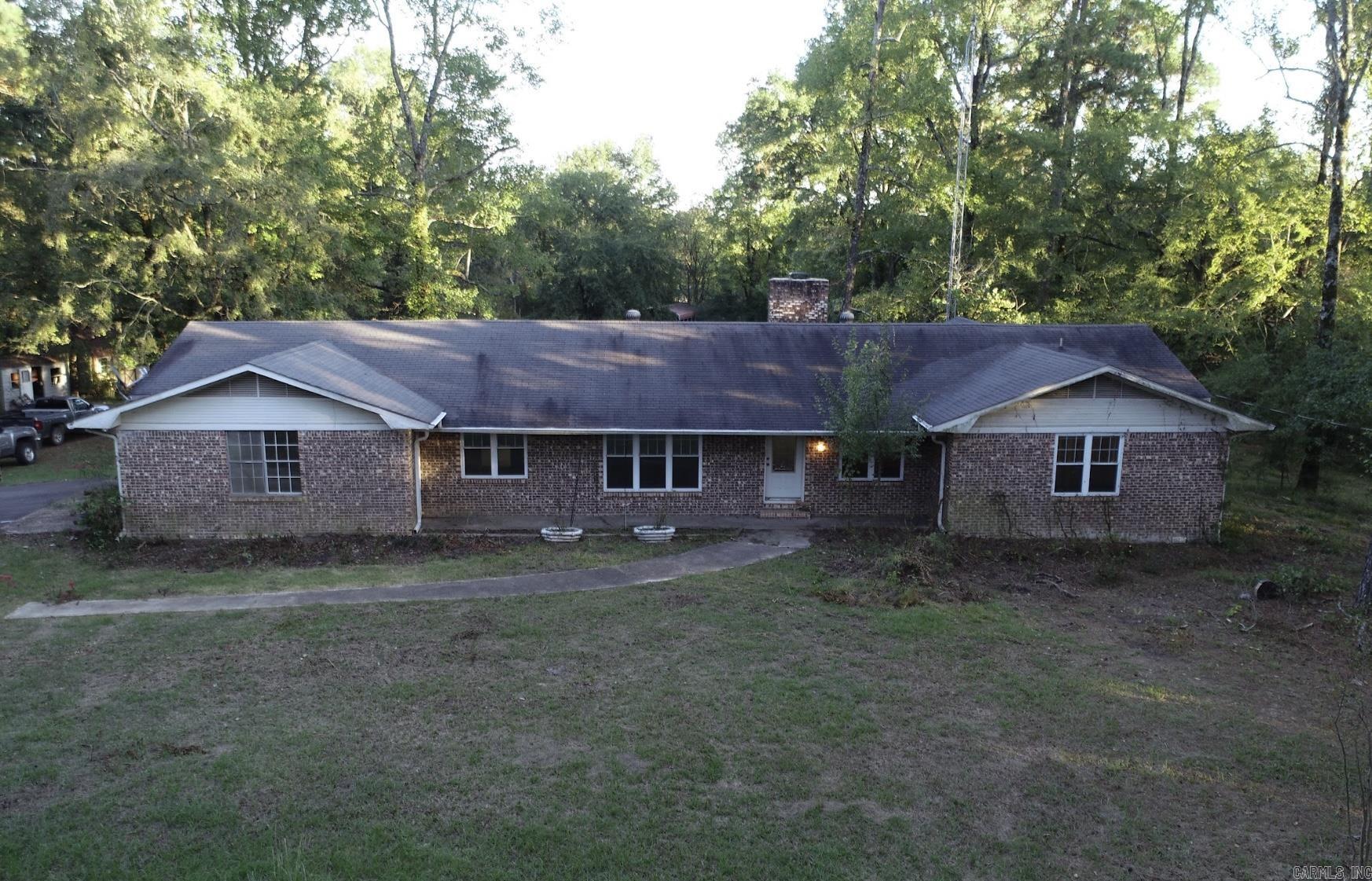Home features 3BR/2BA , Large Bonus Room, Wood burning insert with blowers, located in rural area, large deck, additional utility room, small peach orchard, rural water, 4-states fiber cable at the highway and a storage building.