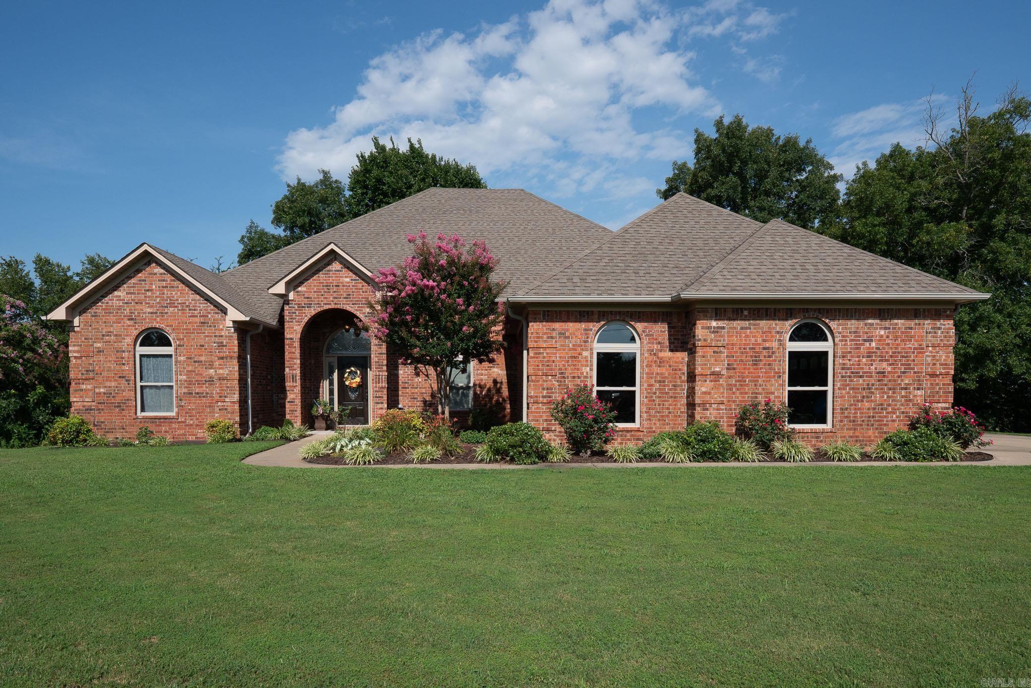 Greenbrier Stunner on Nearly an Acre! This beautifully maintained all-brick home offers timeless curb appeal and modern upgrades throughout. Inside, you'll find a spacious layout with a mix of luxury vinyl and hand-scraped hardwood flooring, soaring ceilings, and abundant natural light. The elegant double-sided fireplace warms both the inviting living room and the sun-drenched sunroom, perfect for relaxing or entertaining. The kitchen features rich stained cabinetry, granite countertops, double ovens, and a spacious pantry. Energy-efficient touches include low-flow plumbing fixtures and extra insulation, plus there's tons of floored attic storage. Step outside to enjoy new decking and beautiful views from your nearly 1-acre lot, all complemented by mature landscaping. A rare three-car garage adds extra value to this must-see home! You'll want to take a look as soon as possible, call today!