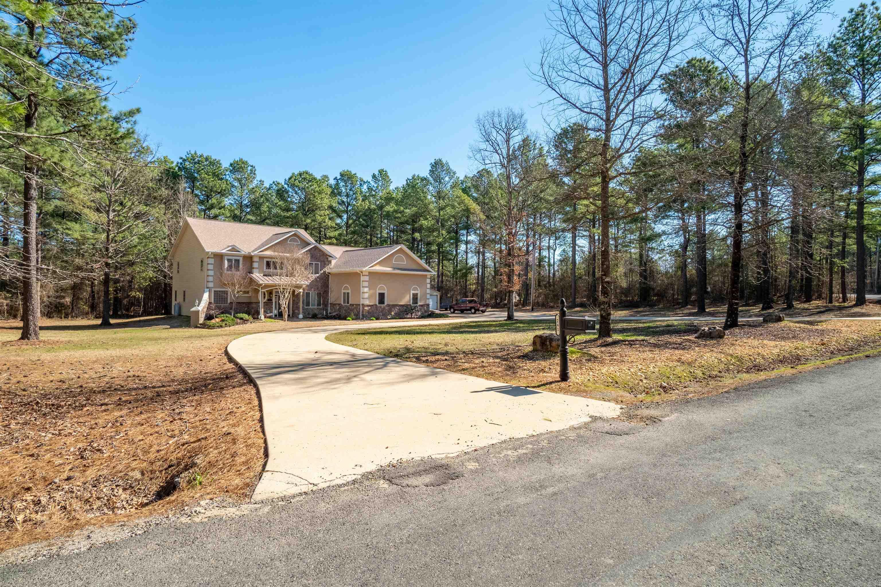 Step into this elegant custom home & be instantly enchanted! Wonderful division of space and space for everyone on your Thanksgiving list - with 5 bedrooms and 4 baths! Some of the special features: large concrete circular driveway, Pergola covered deck; sauna, uplights upper & lower, leaf covers over all gutters: illumination lights in ground (time/date controllable). Inside - family room features rock wall to 26' ceiling with beams; gas log fireplace; recently painted all inside walls. Large chefs kitchen & much more that you will just have to see. This house is just outside Hot Springs Village without HOA dues. Want a garden? Is 3 acres big enough? Primary bedroom/bath on main floor. 3 Bedrooms upstairs. Bonus room/media/work out room located upstairs. Detached 12X25 shed with electricity, and 3 car garage. Beautifully landscaped. SEE AGENT REMARKS
