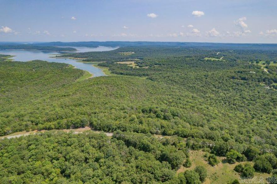 Discover your own Ozark haven on this 40-acre wooded ridge in Peel, AR, just an hour from Branson, MO and minutes from Bull Shoals Lake. Imagine your dream home or hunting cabin perched atop this hardwood-rich property. With electric service available and paved road frontage on Hwy 125, building your ideal retreat is within easy reach. Bordered by government land on two sides, this property offers unparalleled privacy and recreational opportunities. Claim your piece of Arkansas paradise – call today!