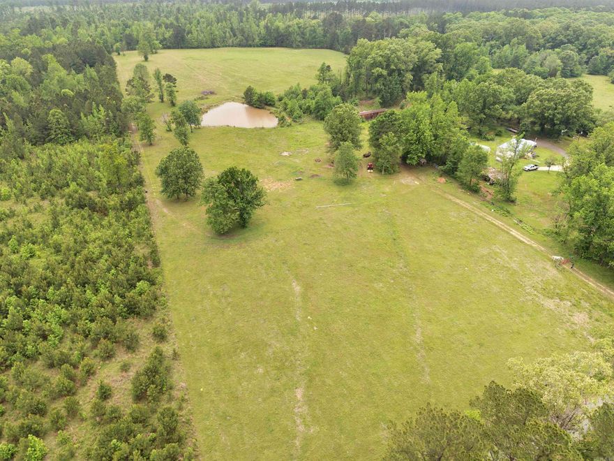 Acreage that is ready to build on! You’ll have open pasture & timber for livestock, hunting or recreation. Plenty of privacy with this stunning 56.18-acre property. Approx 16 acres of beautiful pastureland and a 40-acre block of timber.  The pasture includes a scenic pond and already fenced and has water access, making it an excellent homesite.  For hunters and outdoor enthusiasts, the timber acreage is a dream come true with established trails, shooting lanes, and abundant wildlife—perfect for hunting right in your own backyard. Need more space or a place to stay right away? There is also the option to purchase an additional 3.82 acres with a mobile home adjoining the property. Whether you’re looking for a private retreat, hunting haven or just room to roam, this property checks all the boxes. Don’t miss your chance to own a rare mix of pasture, pond, and timber all in one tract!