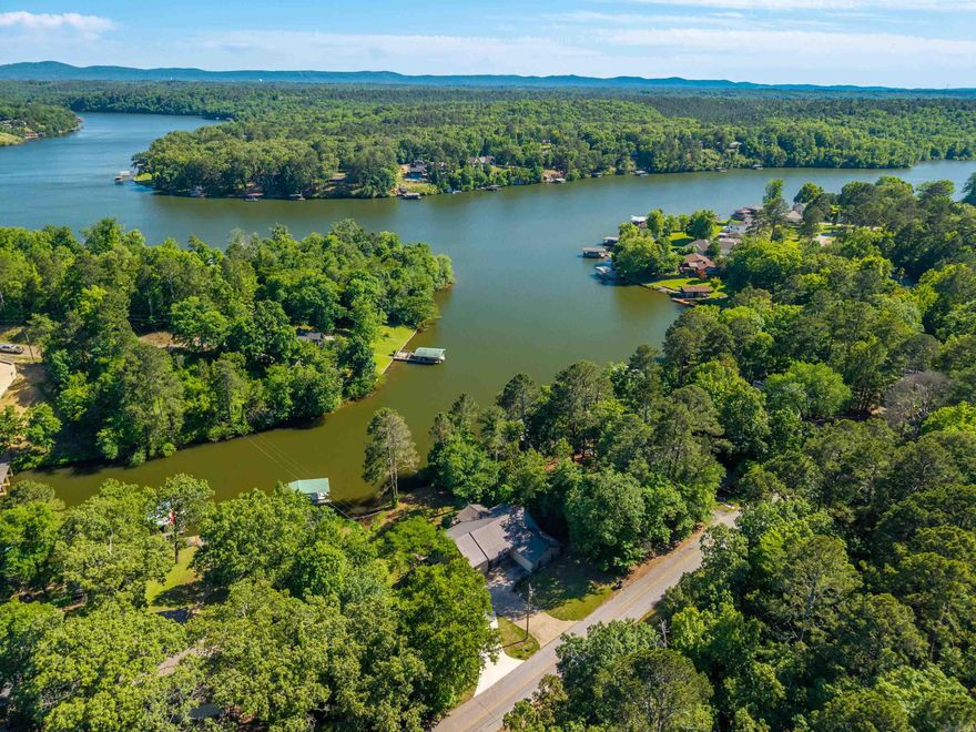 This lake house has it all, welcome to 415 Kirschwwod Drive! Spacious 3 bedroom, 3 bath home featuring a versatile bonus room downstairs, perfect for a game room, office, or guest space. 2 car garage with a brand new driveway, separate laundry room, large walk in closet and tons of storage space downstairs! Nestled in a year-round deep-water cove with a private boat dock, 140ft of water frontage, this property offers easy access and exceptional waterfront living. The covered back deck offers views of the main channel and perfect for entertaining! Located right down the street from Treasure Isle boat ramp and out of city limits, this could be a lucrative short term rental!
