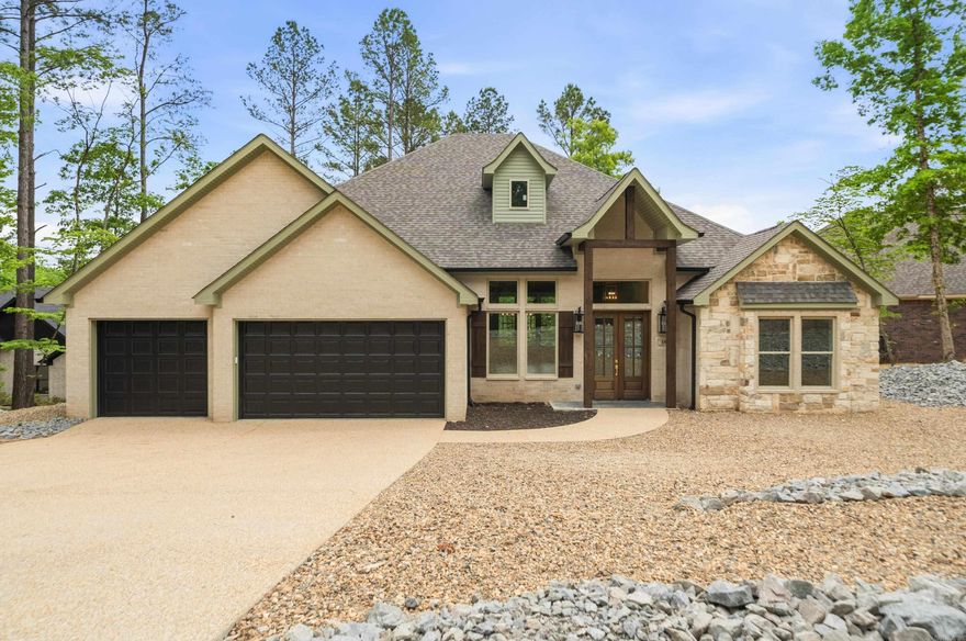 Experience lake living in this beautiful new construction home on Lake Granada in Hot Springs Village, built by Carriage Custom Homes. Designed with an inviting open floor plan, this home offers effortless living and entertaining with thoughtfully selected finishes and quality craftsmanship throughout. The spacious living area flows seamlessly into the kitchen and dining space, creating a bright and welcoming atmosphere. Beautiful finishes, custom details, and large windows bring in natural light while highlighting the peaceful lake setting. Enjoy relaxing mornings and evenings overlooking Lake Granada, a quiet lake known for fishing, kayaking, and swimming. Located inside Hot Springs Village, the largest gated community in the United States, residents enjoy access to numerous amenities including golf courses, lakes, trails, fitness centers, and an active lifestyle community. Whether you're looking for a full-time residence or a peaceful retreat, this thoughtfully designed home offers the perfect combination of modern comfort, scenic surroundings, and active lifestyle amenities. Real estate taxes are based on unimproved lot. Consult tax assessor for tax rate.