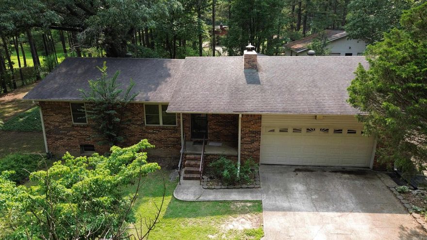 Spacious 4-bedroom, 3-bath home with over 2,600 sq ft of living space, nestled on a large, tree-filled lot at the end of a quiet dead-end road. The main level features a cozy living room with a wood-burning fireplace, a generous kitchen and dining area, and access to a large covered deck—perfect for relaxing or entertaining. The walkout basement offers a second kitchen, a comfortable den, two additional bedrooms, and a full bath—ideal for multi-generational living or guest space. A detached shop building adds extra functionality for hobbies, storage, or a home business. Enjoy the peace and privacy of mature trees and a spacious yard in this unique and versatile property.