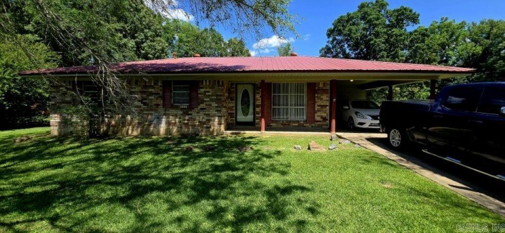 This charming home sits nestle on a large parcel on a dead-end street. Step into kitchen dining combo, with an add bonus room making entertaining a breeze or could be made into a 4th BR with fireplace. Laminate and Tile floors throughout. Kitchen recently updated. Metal roof and huge back yard for perfect for outdoor activates. Located in a quiet neighborhood. Welcome to comfort living.