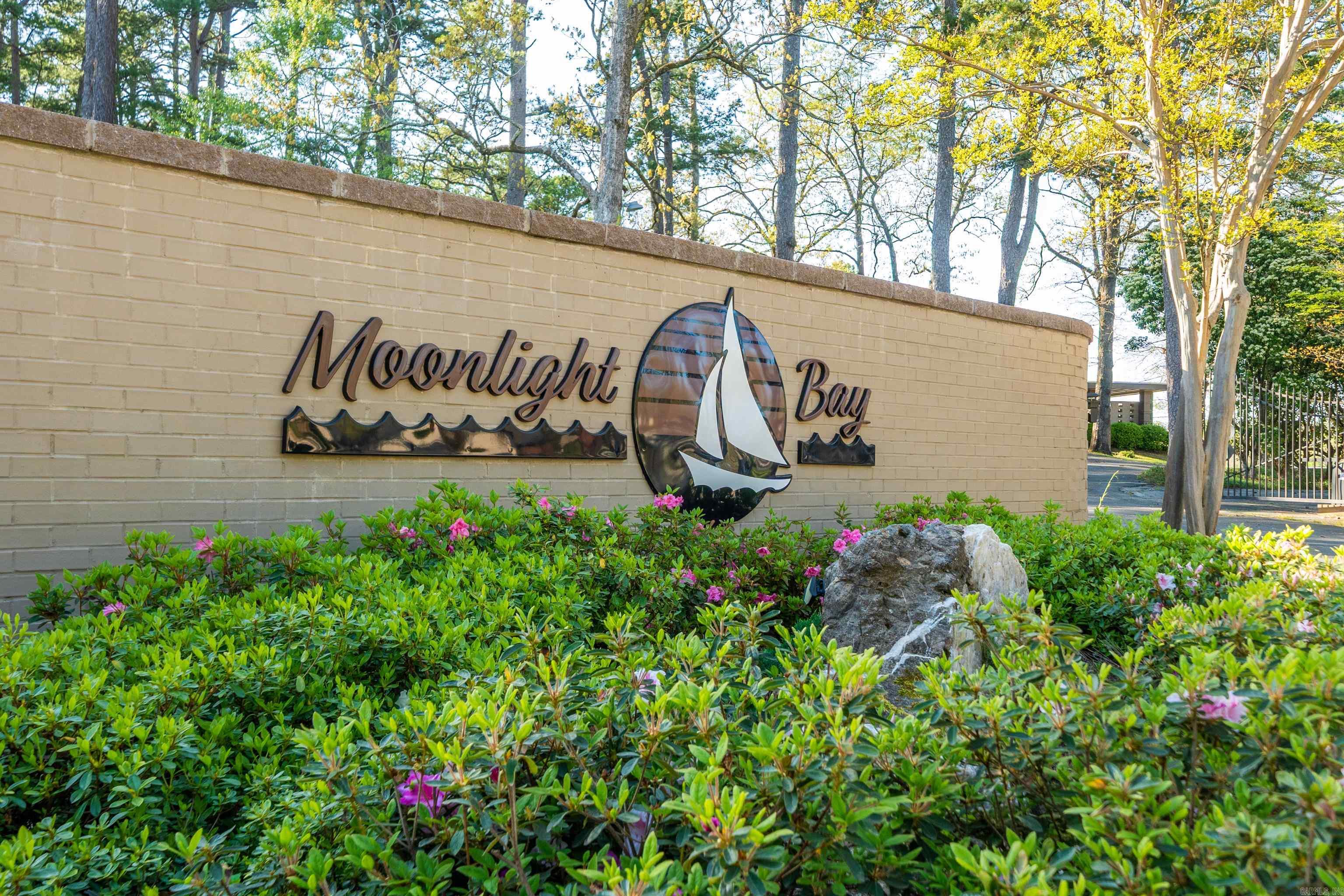 Moonlight Bay Condo is a gated community surrounded by mature trees. Stunning 2-bedroom 2-Bathroom offering privacy and comfort! Light and bright! Spacious master suite with sitting area! Very open floor plan, vaulted ceiling in living area. Landscaped patio and separate private porch - perfect for relaxation! Recently remodeled kitchen, bathrooms, plus new HVAC and new roof. Located near Lake Hamilton, minutes away from Historic Hot Springs and close to Oaklawn Racetrack and Casino. Don't miss out on this exceptional opportunity to own a piece of paradise!