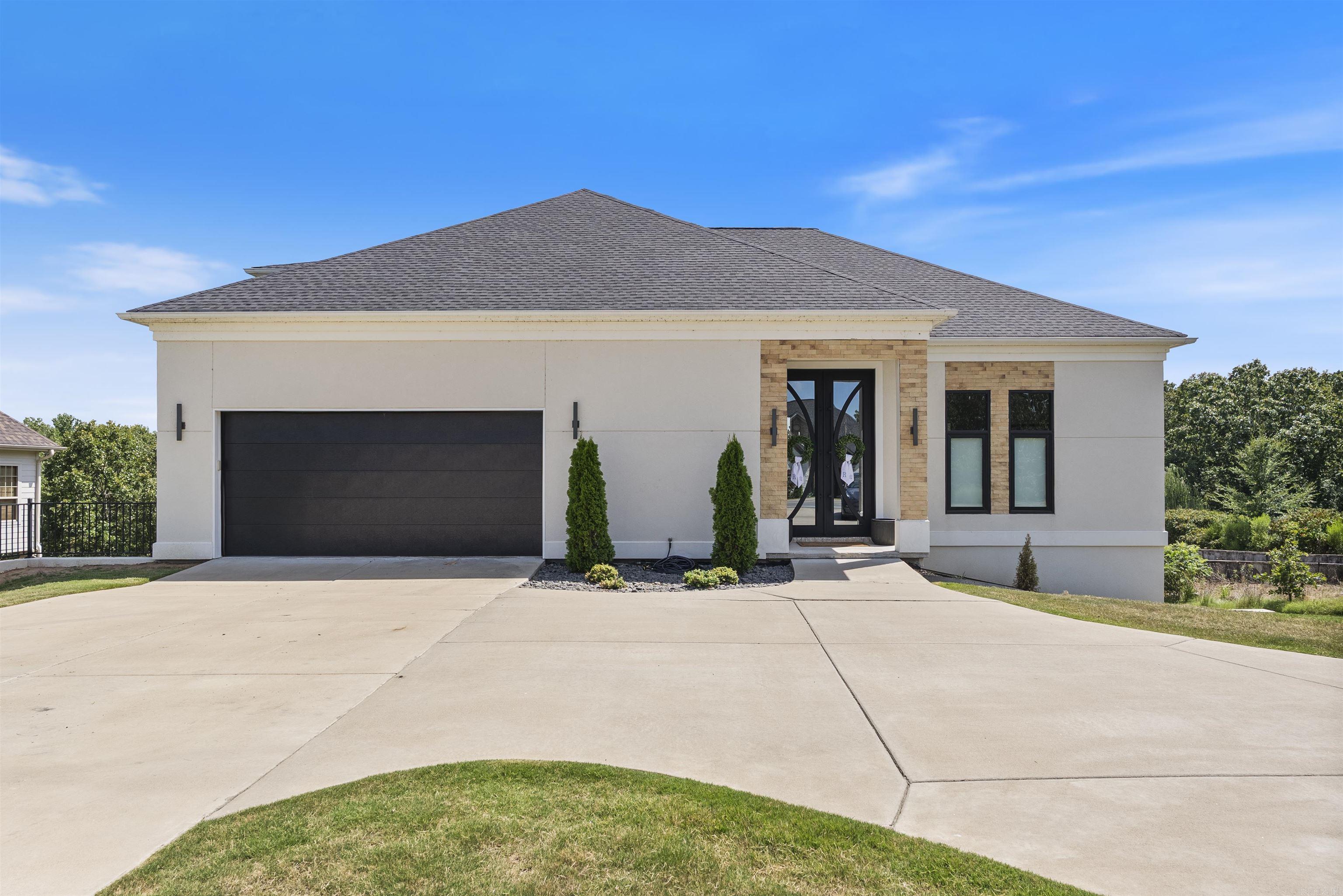 Modern luxury meets functional design in this stunning home located on the water in the sought-after Greystone Subdivision. The main level features a spacious primary suite with floating double sink vanities, a tile walk-in shower, and a relaxing soaker tub. The primary bedroom connects to a private office, which also has access to the living room, where youāll find an electric fireplace for cozy evenings. The sleek, modern kitchen is a showstopper with its waterfall island and breakfast bar, built-in refrigerator that blends seamlessly with the floor-to-ceiling cabinetry, gas cooktop, wall oven, and microwave. Upstairs offers a private retreat with a bedroom and full bath, perfect for guests. The walkout basement is an entertainerās dream, featuring a large open area with a pool table and sitting area, two additional bedrooms, a full bath, a media room, oversized drink fridge, bonus space currently used for a golf simulator, and a workout room that is in the process of being finished out. Enjoy peaceful water views from your own backyard, this home truly has it all.