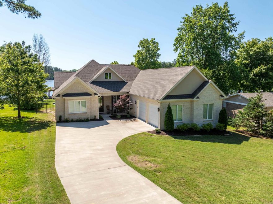 Awesome like new lake home built in 2021. This home has been lived in by the owner as a 2nd home and in excellent condition. Very nice level lot with East facing back yard on deep water channel. Great views of the lake from the 2 covered porches. Owner spent $100k after closing building a new boat dock with lift, wrought iron fencing and landscaping. Boat dock has a sun deck and ladder. Irrigation system uses lake water. Nearly .75 acre lot with appprox. 100 ft of shoreline. Wonderful gas firepit for those chilly nights. Extended concrete driveway from the street to the oversized double garage. Beautiful front entry leads to an open floorplan. Great room with vaulted ceilings and lots of built-ins. Gas logs in Fireplace along with wet bar, commercial ice maker and built-in refrigerator. Beautiful kit with granite counter tops and upgraded appliances. Very nice walk-in pantry. Breakfast bar plus separate breakfast/dining room overlooking backyard. Split bedroom plan with a primary bedroom, 2 walk-in closets and luxury bath. 2nd and 3rd bedroom on opposite side of home with Jack & Jill bath. 4th BR up with sitting area & full bath. Security System and tankless water system.