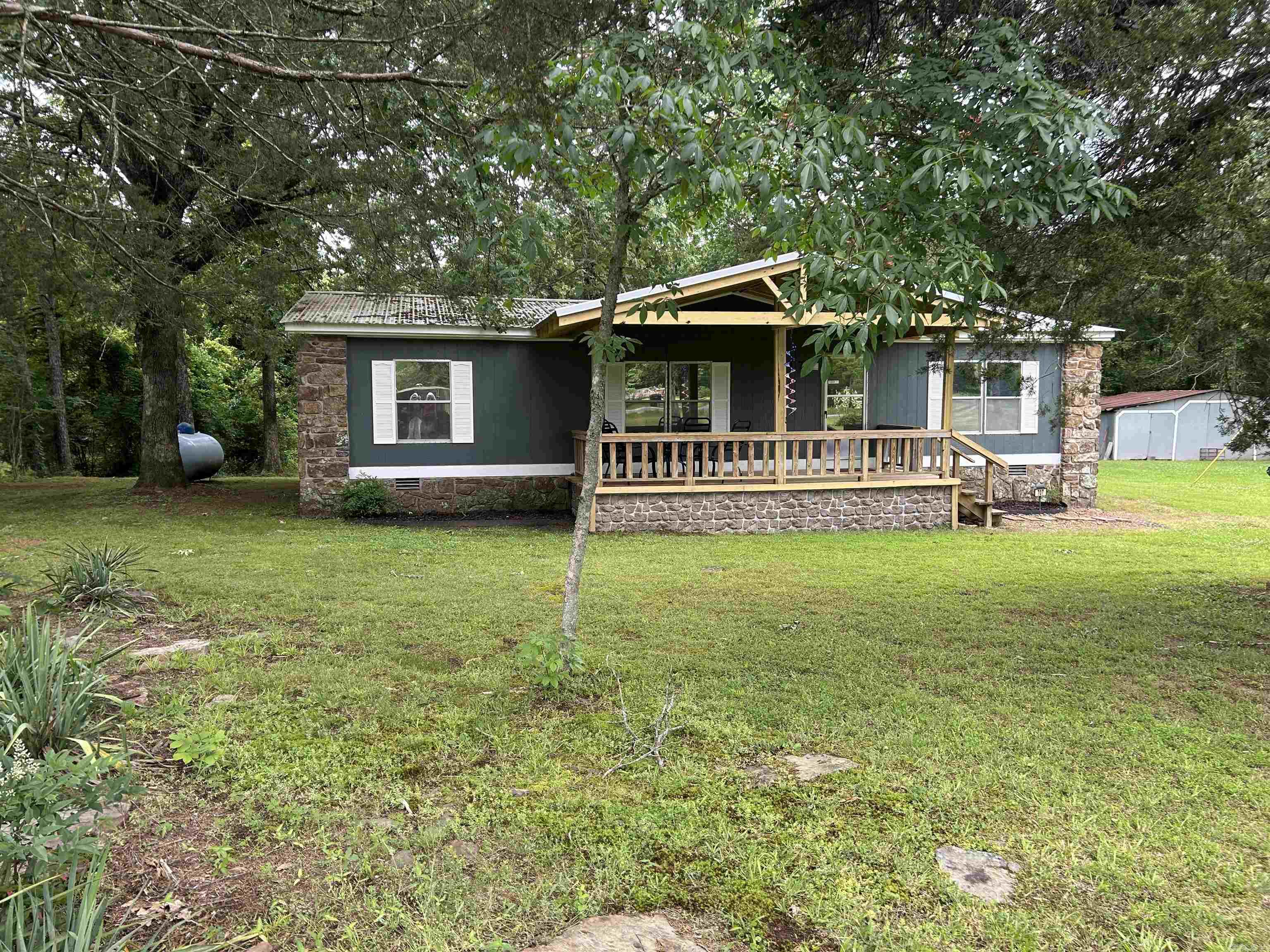 Weekend Lake Getaway - Perfect for VRBO or Personal Escape! This well maintained 3 bedroom, 2 bath home is the perfect family home, weekend retreat, or use as a rental opportunity. Large living room with fireplace, split floor plan, fully furnished and sitting on approximately 1.65 acres. Very nice covered decks on front and back of home to entertain or just relax.