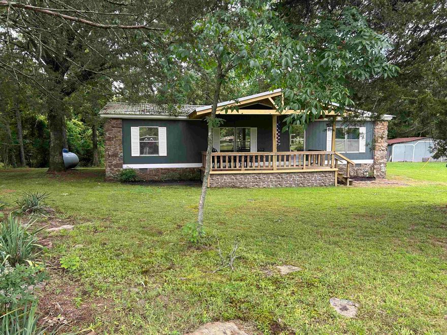 Weekend Lake Getaway - Perfect for VRBO or Personal Escape! This well maintained 3 bedroom, 2 bath home is the perfect family home, weekend retreat, or use as a rental opportunity. Large living room with fireplace, split floor plan, fully furnished and sitting on approximately 1.65 acres. Very nice covered decks on front and back of home to entertain or just relax.