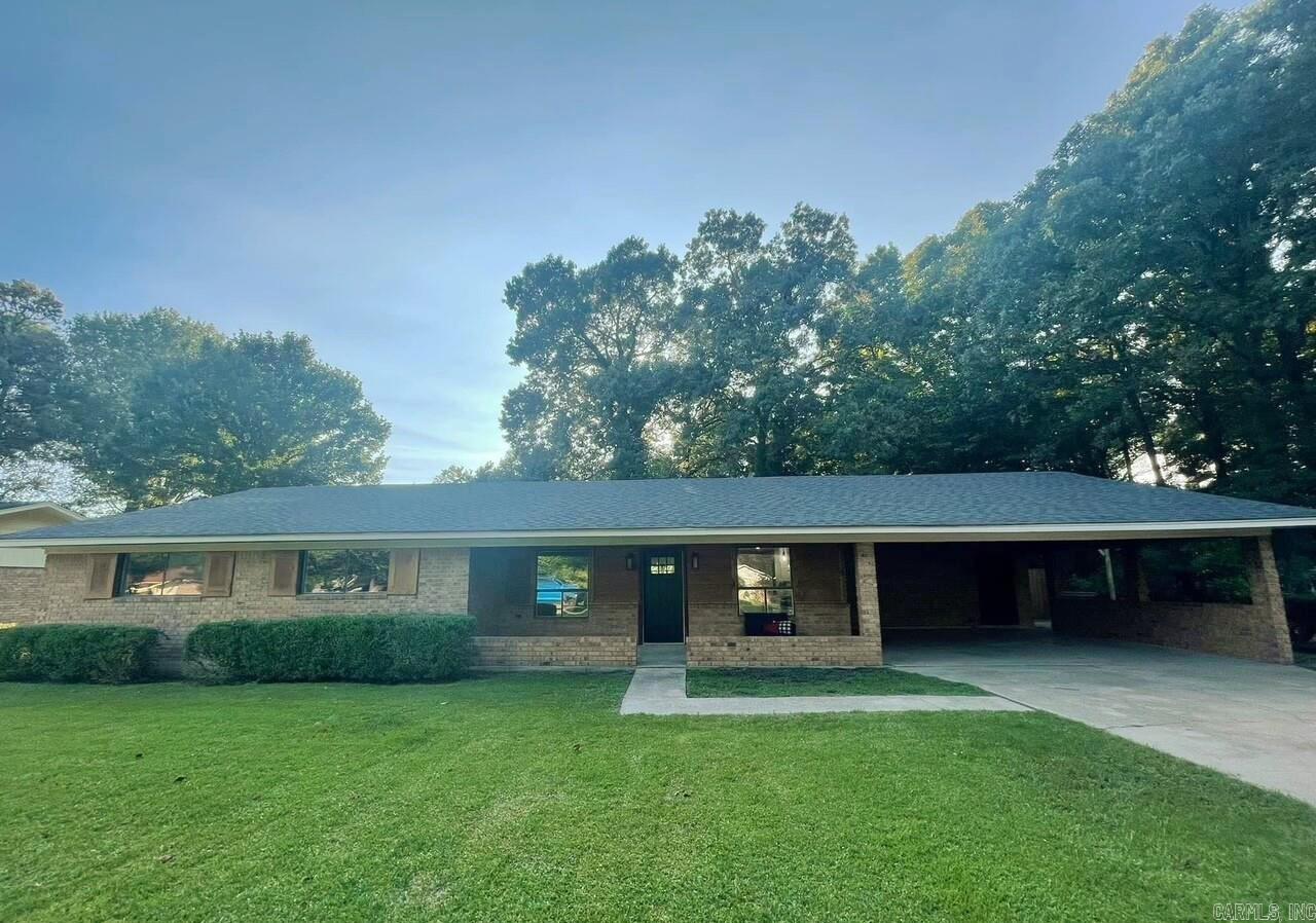 Gorgeous house! Completely remodeled in 2022 from top to bottom.  Beautiful kitchen with granite counter tops, deep sink, lots of cabinets, large bar with tons of storage. Laundry room with half bath. (sink and toilet). Living room/dining area is ALL open to the kitchen. Fireplace with gas lots. Features an office in the front of the home.  Three bedrooms and two bathrooms.  Both bathrooms have beautiful tile work. Primary bedroom has a nice walk-in closet. Backyard is fully fenced with a wood privacy fence and covered back porch.  Large storage room under the carport.  Home also has an extra lot across the street. (503 Pecan) This will be included in the purchase. Property is the last house on a quiet dead-end street.
