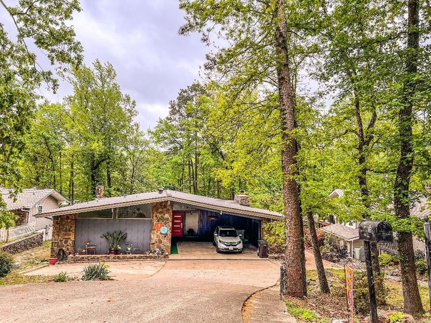 Lake living in HSV! So many options for this mid-century beauty. Vacation home, multi-family home-options! Ceilings soar 8' to 12' upstairs. FP with a sitting mantel fashioned by a local cabinet maker(2023), carpet removed-LVP upstairs, complete tear-out of kitchen, expanding it by more than 300%(2021).  750 sft covered deck received metal railing (2025). The primary "ensuite" baths were demolished (that's right, two tiny bathrooms).  The expansive shower is the size of the original bath. Dramatic octagonal tile flows from the shower throughout the bath. Attractive penny tile on the shower floor for safety.  Grab bars installed, rain shower with wand completes the luxury (2025). Major remodel in the lower level: new windows, retro Terrazzo look tile flooring. Complete removal of old brown paneling, replaced with sheet rock. Old cabinets were replaced with custom cabinets throughout. A wall was added to change the studio apartment into a one-bedroom apartment. Virtually all outlets, fans, and lights were replaced. A door was added at the base of the stairs to ensure privacy (2023). Stair rail and newels added in 2023. All major appliances can convey. Pontoon boat does not convey.