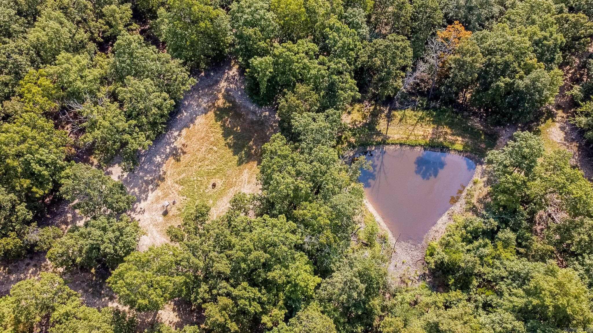 Located in the heart of the Ozarks in Ravenden, Arkansas, this exceptional 290 +/- acre property spans both Randolph and Sharp counties and offers a true turn-key experience for outdoor enthusiasts. The land has been meticulously maintained and thoughtfully developed, featuring over 5 miles of well-kept internal roads, multiple food plots, two natural springs, and two ponds. Wildlife is abundant, with a thriving population of deer, turkey, and the occasional bear. Hunting infrastructure is already in place with four enclosed box stands, eleven ladder stands, and twelve feeders strategically positioned across the property. The property includes a fully furnished 2017 16'x80' mobile home, a 20'x40' shop for equipment storage, and a deer cooler - perfect for weekend getaways or full-time living. Also included is a 2022 John Deere 5090E tractor with a 5-foot Remlinger no-till drill and several other implements, making land management easy and efficient. With high-speed fiber internet already installed and located just 50 miles from Jonesboro, this property offers the perfect blend of seclusion, comfort, and accessibility.