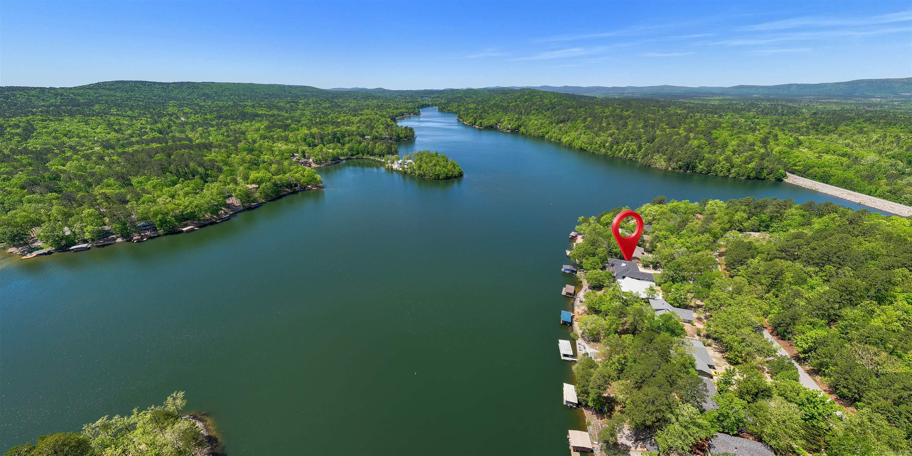 WOW! What a GORGEOUS Remodel! Top to bottom, this Premium Lake Cortez Waterfront Home has been Elegantly Renovated to reflect its true potential! With 4 Bedrooms + Den + Bonus, 3 Fireplaces and a HUGE Storage Room with Utility Sink and added Closets, this home has room for everything, including multi-generational living or income potential As you enter, Pristine Lake Views greet you from floor to Vaulted Ceiling Windows! Be Wow'd by Lake Views from nearly every room, including the newly designed Great Room with Wet Bar. The adjacent Kitchen has all New, Stainless Appliances (including 3 Ovens + Convection Oven/Microwave), Custom Cabinetry, Elegant Glass Backsplash, and beautiful Quartzite Countertops. Choose to dine from your Lake View Center Island (with ample storage), Kitchen Nook with Crystal Chandelier, entertainment-sized Formal Dining Room or your Huge Outdoor Deck. The expansive Lake Views continue into your Spacious Primary Bedroom with a Spa-like Ensuite and Walk-in Closet! The Lower Level features a Lake View Living Area, 2 Bedrooms and a Flex Room. Walk-out to the Patio and Fully Fenced Yard to enjoy Lake Living from your Covered Boat Dock! Aprox. 70' Waterfront!