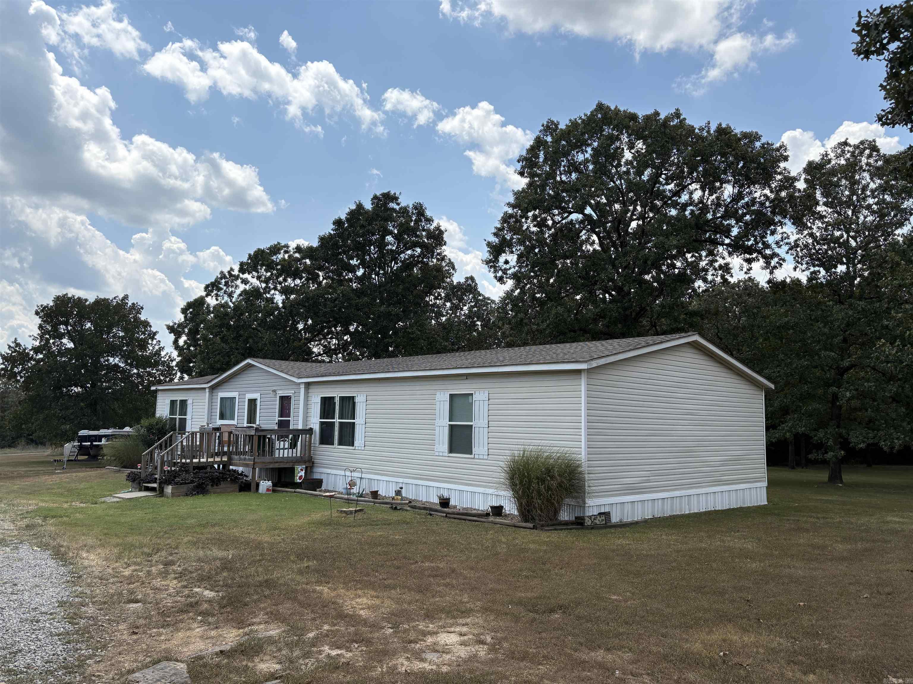 From the moment you pull up, youāll feel the peace of 3 full acres all your own with a shady backyard, a sparkling pond, your own water well, a circle drive, and plenty of open space begging for gardening, entertaining, or parking the boat, RV, and all your toys. Step inside and youāll find 1,960 square feet of updated, modern comfort. The split bedroom floorplan gives everyone privacy, and every bedroom is extra spacious. The kitchen? Huge, with room for multiple families or friends to gather around the table and it flows right into the living space so nobody misses a moment. Built in 2017 and installed on this property in 2021, the home has a brand-new shingled roof and a vibe thatās all fresh, bright, and move-in ready. Here, youāve got country solitude, room to breathe, and a home thatās ready for your next chapter. So ask yourself, do you really love going home?