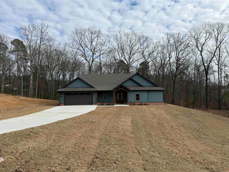 Welcome to your new construction home, where modern elegance meets comfort. Boasting great curb appeal, this residence welcomes you with an inviting open concept design, accentuated by kitchen cabinets and adorned with beautiful countertops. The kitchen features soft-close cabinets doors and top-of-the-line stainless steel appliances, complemented by elegant light fixtures that add a touch of charm. Cozy up by the gas fireplace in the spacious living room on chilly evenings. This custom-built beauty offers a split floor plan for added privacy, with Luxury Vinyl Plank flooring throughout. Retreat to the spacious primary suite, complete with tray ceilings, a generously sized walk-in closet & an indulgent en suite bathroom featuring a large walk-in tile shower, soaker tub, and double vanities. Additional spacious spare bedrooms offer versatility & comfort. Step outside to your covered patio overlooking the large 2.87 acre wooded lot. Prepare to be impressed by the meticulous craftsmanship and thoughtful design of this exceptional home.